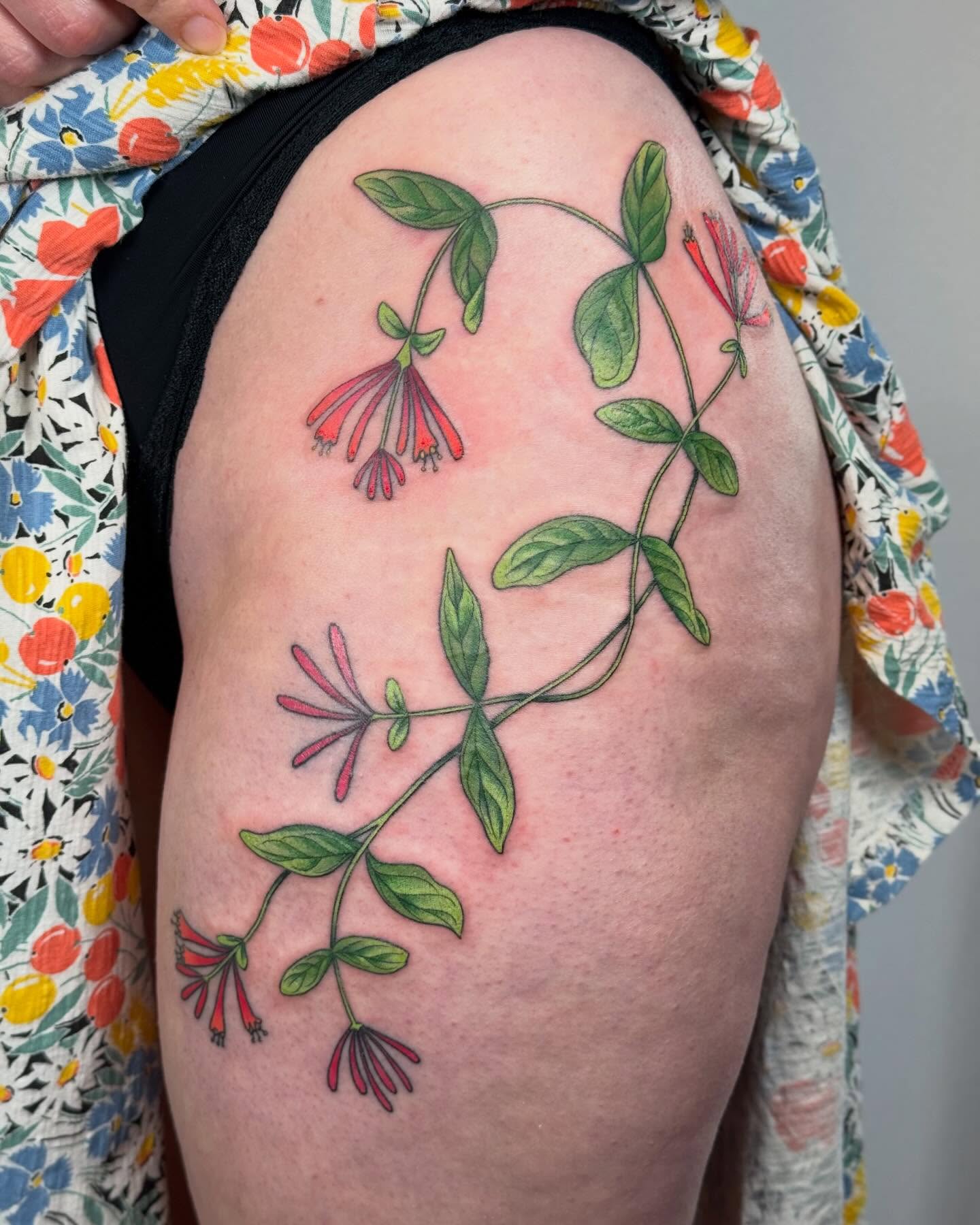 Flower vine realism tattoo on the thigh by Larkin Resler