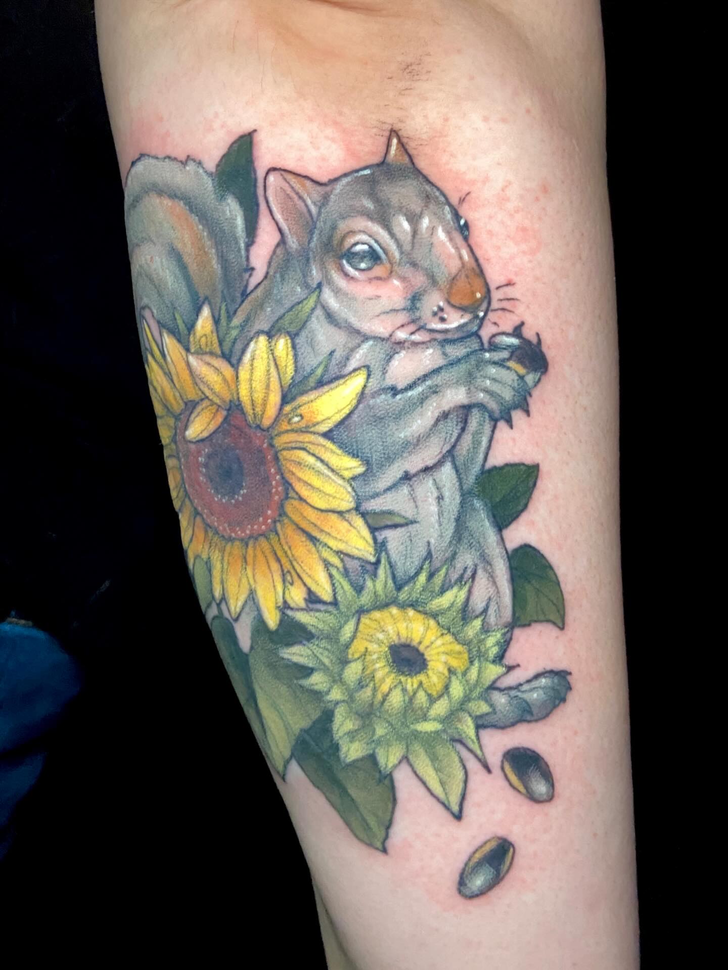 Squirrel and sunflowers realism tattoo on the forearm by Dawn Carr, Richmond, Virginia