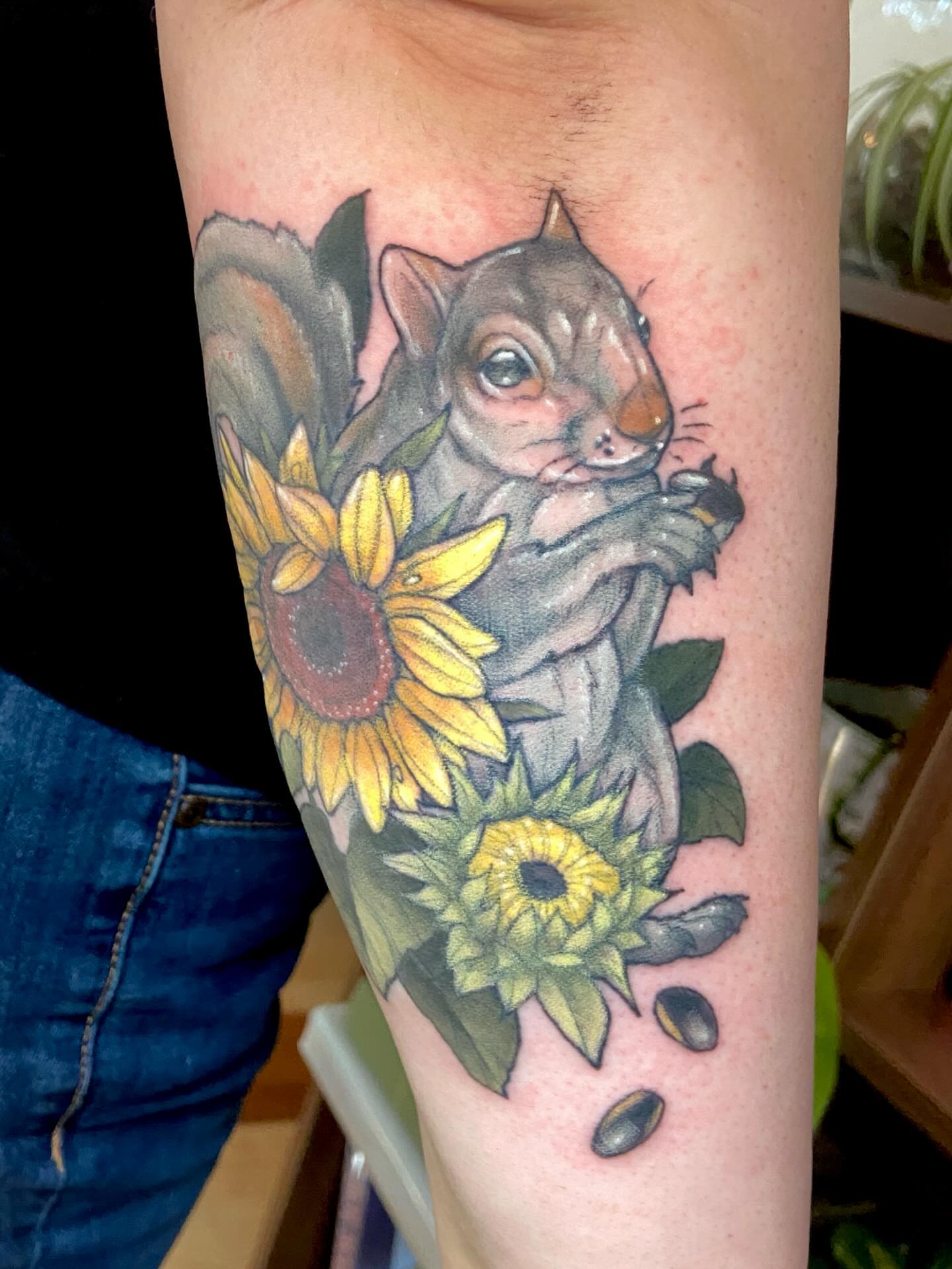 Squirrel and sunflowers realism tattoo on the forearm by Dawn Carr, Richmond, Virginia