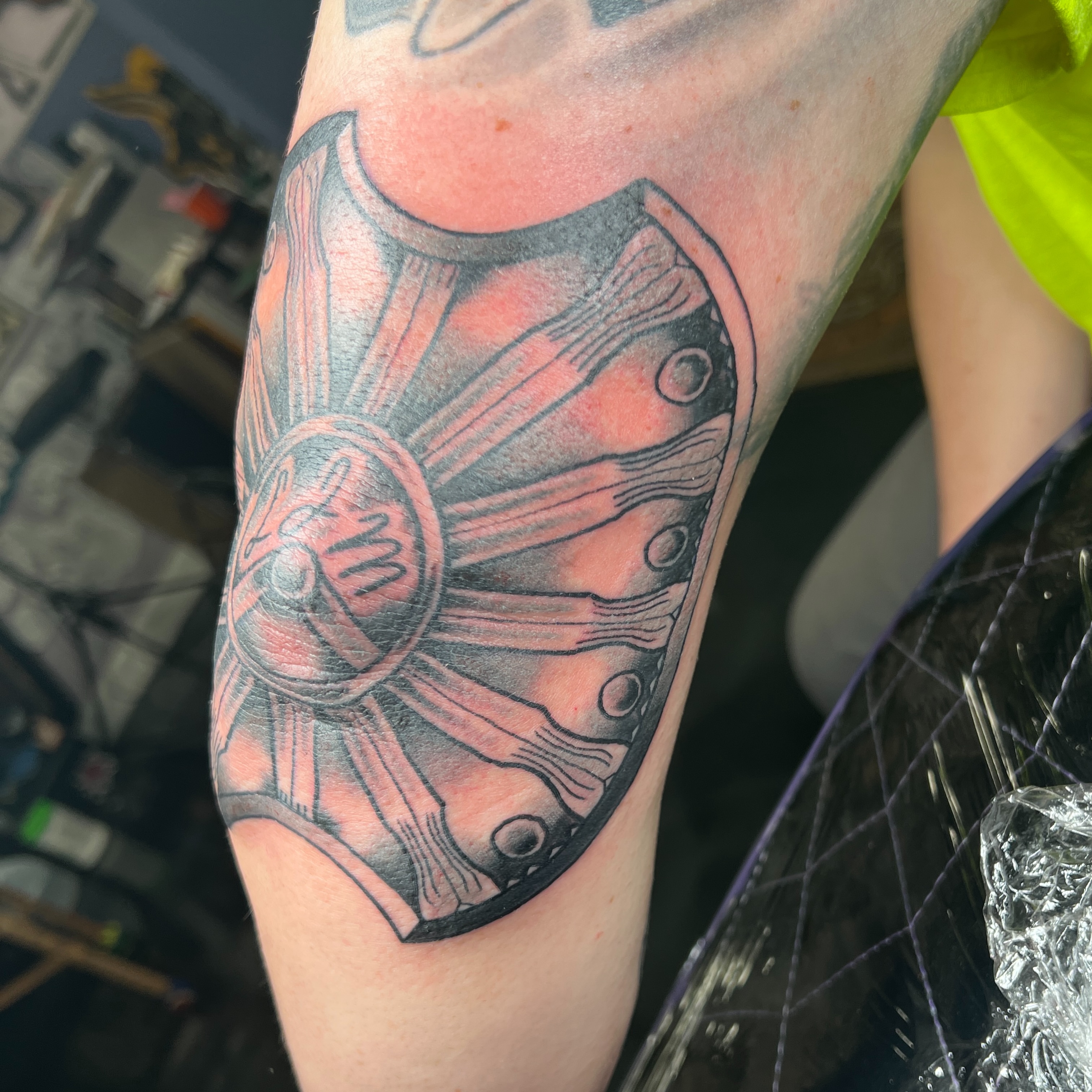 Shield black and grey tattoo on the forearm by Brian Mock
