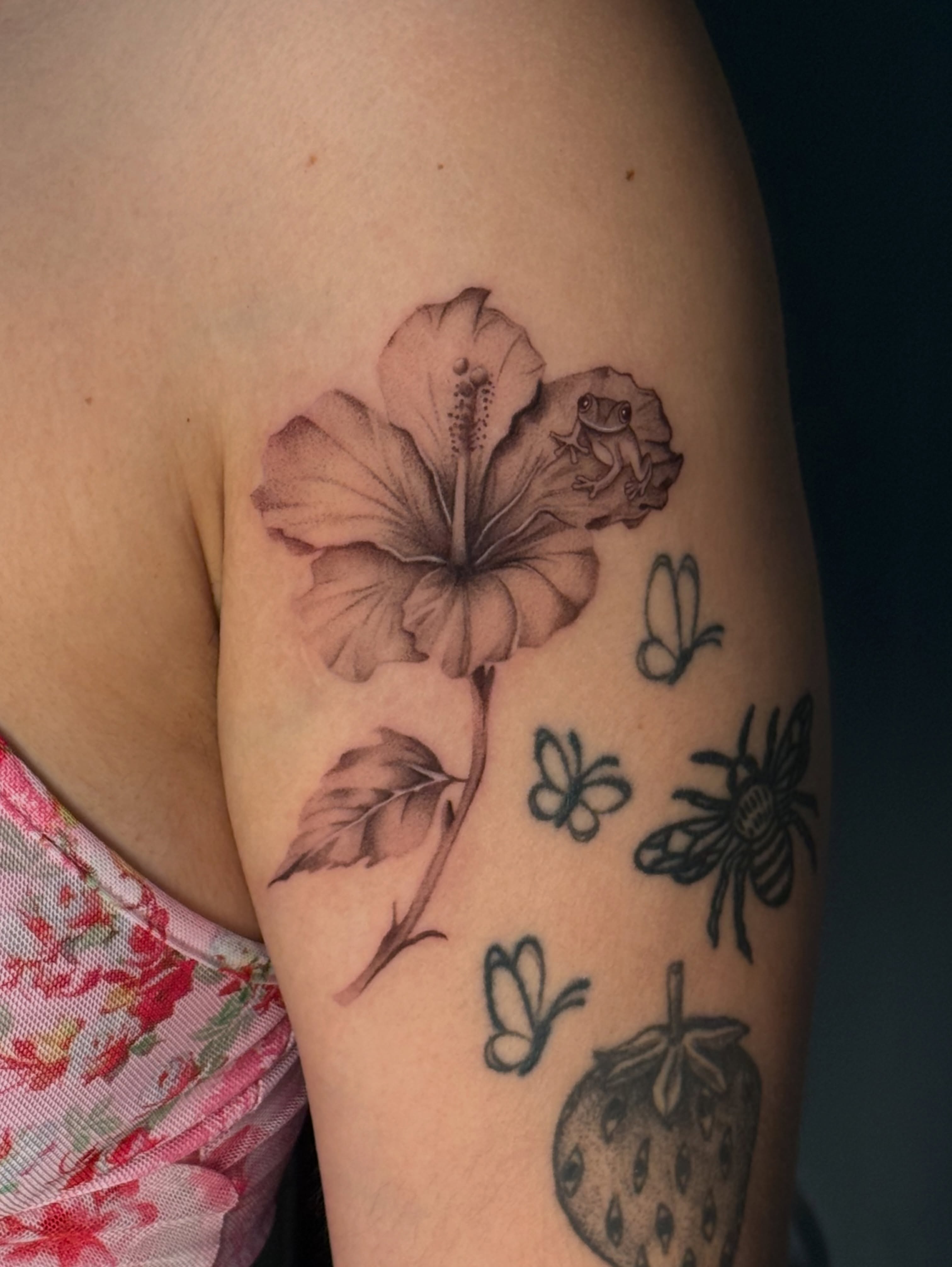 Hibiscus flower black and grey tattoo on the upper arm by jaz🌀