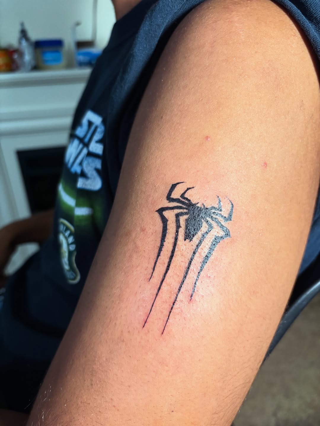 Spider logo blackwork tattoo on the forearm by winrytattoome