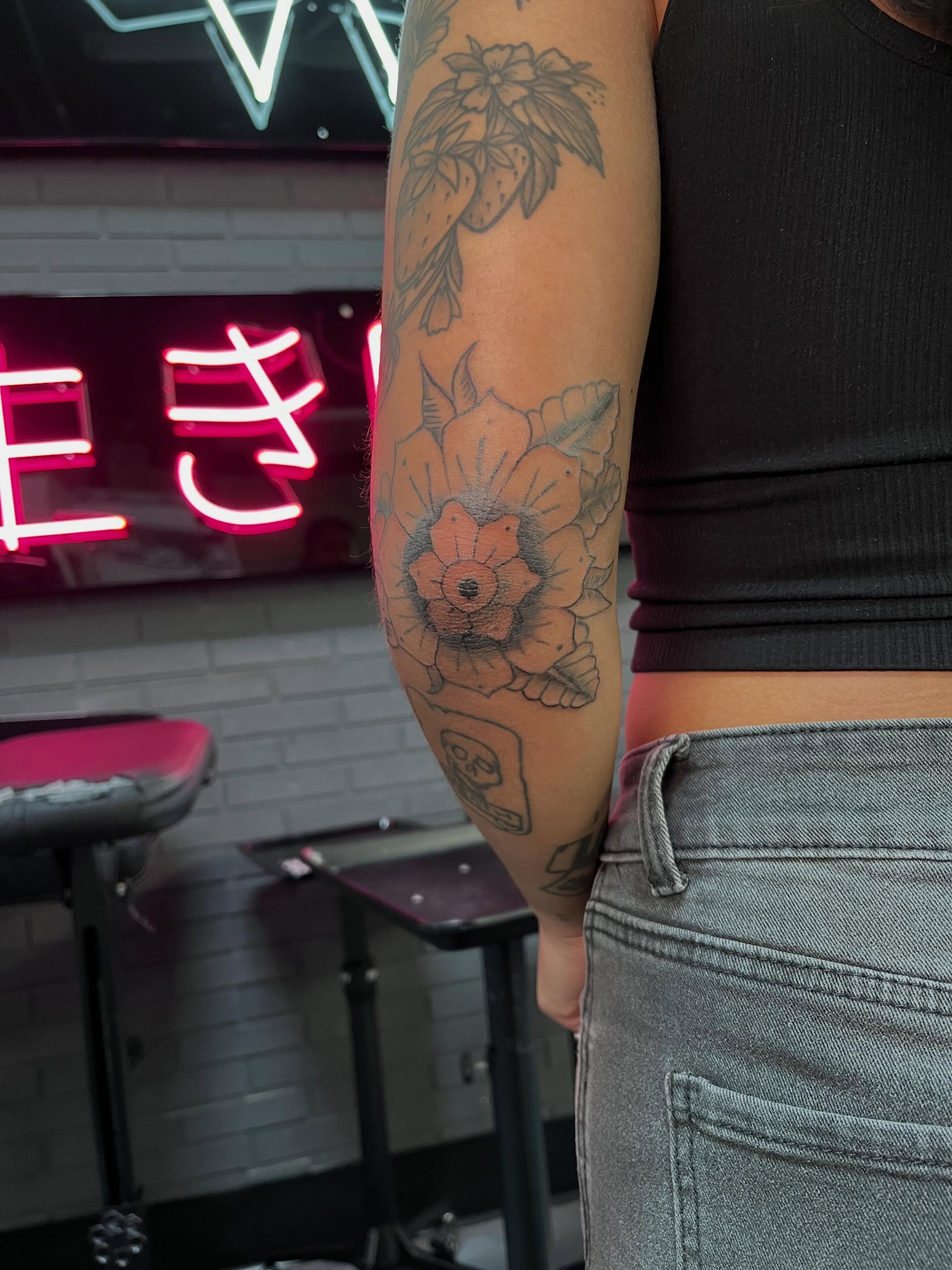 Floral arrangement black and grey tattoo on the forearm by Bunny 🐰