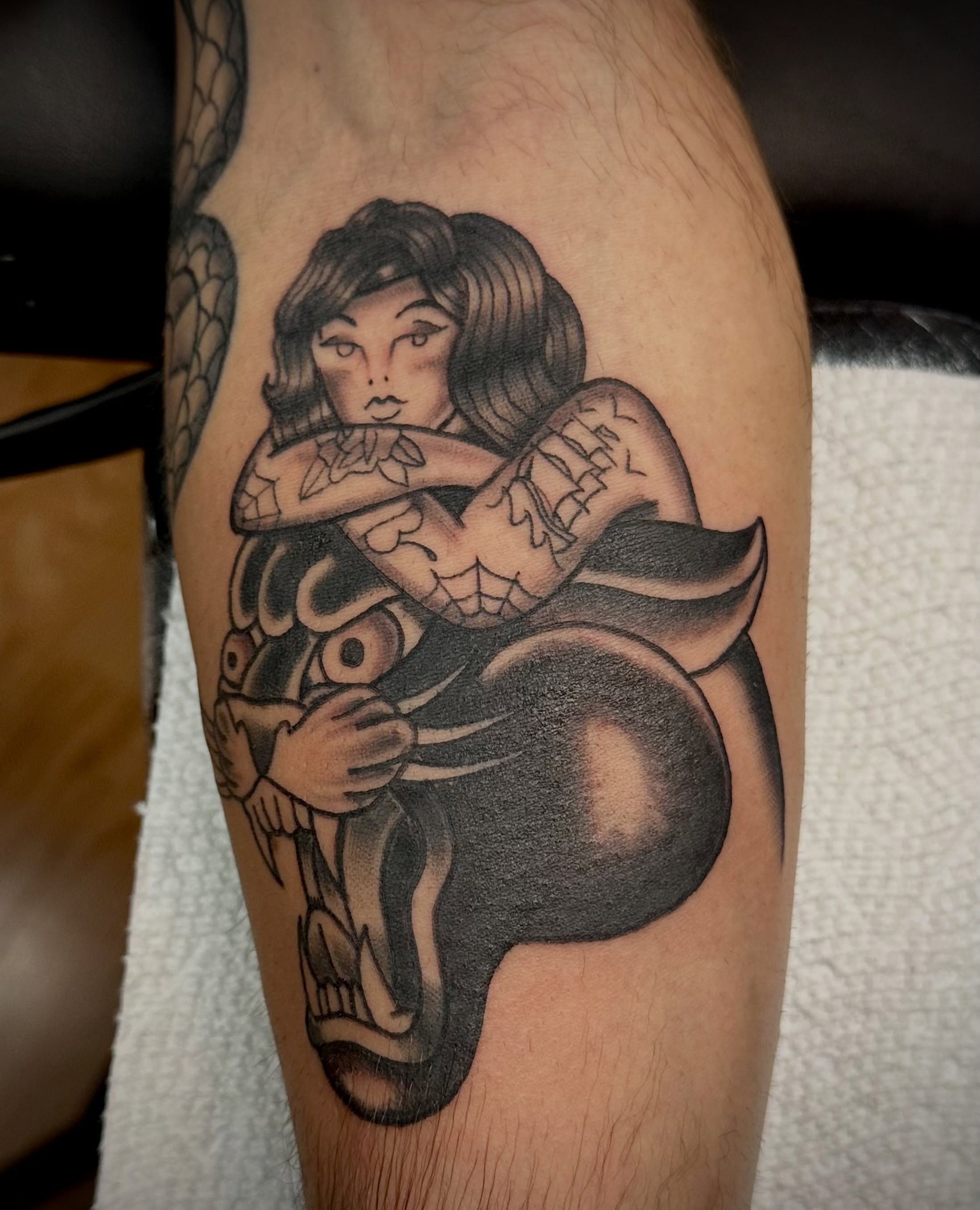 Woman hugging skeleton American traditional tattoo on the forearm by Josh Robinson