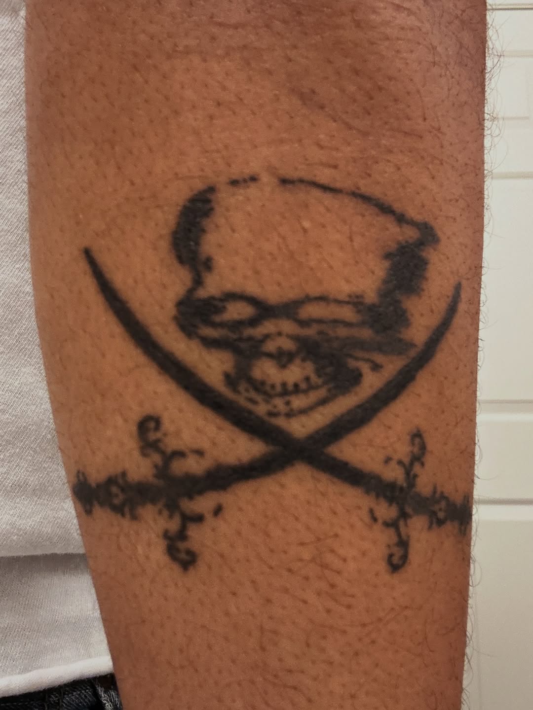 Skull and swords tattoo on the forearm by winrytattoome