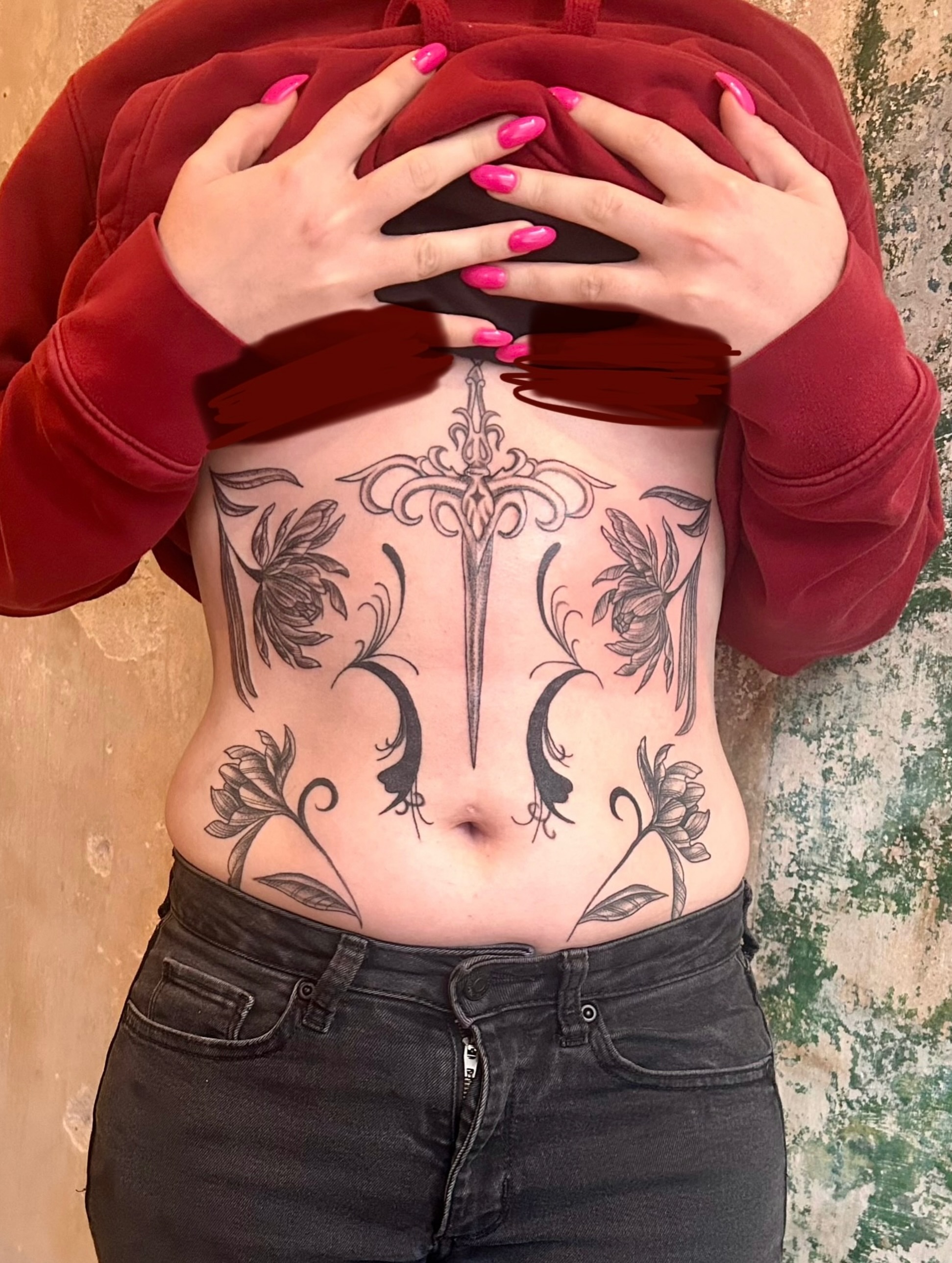 Sword and floral black and grey tattoo on the torso by Tori Magill