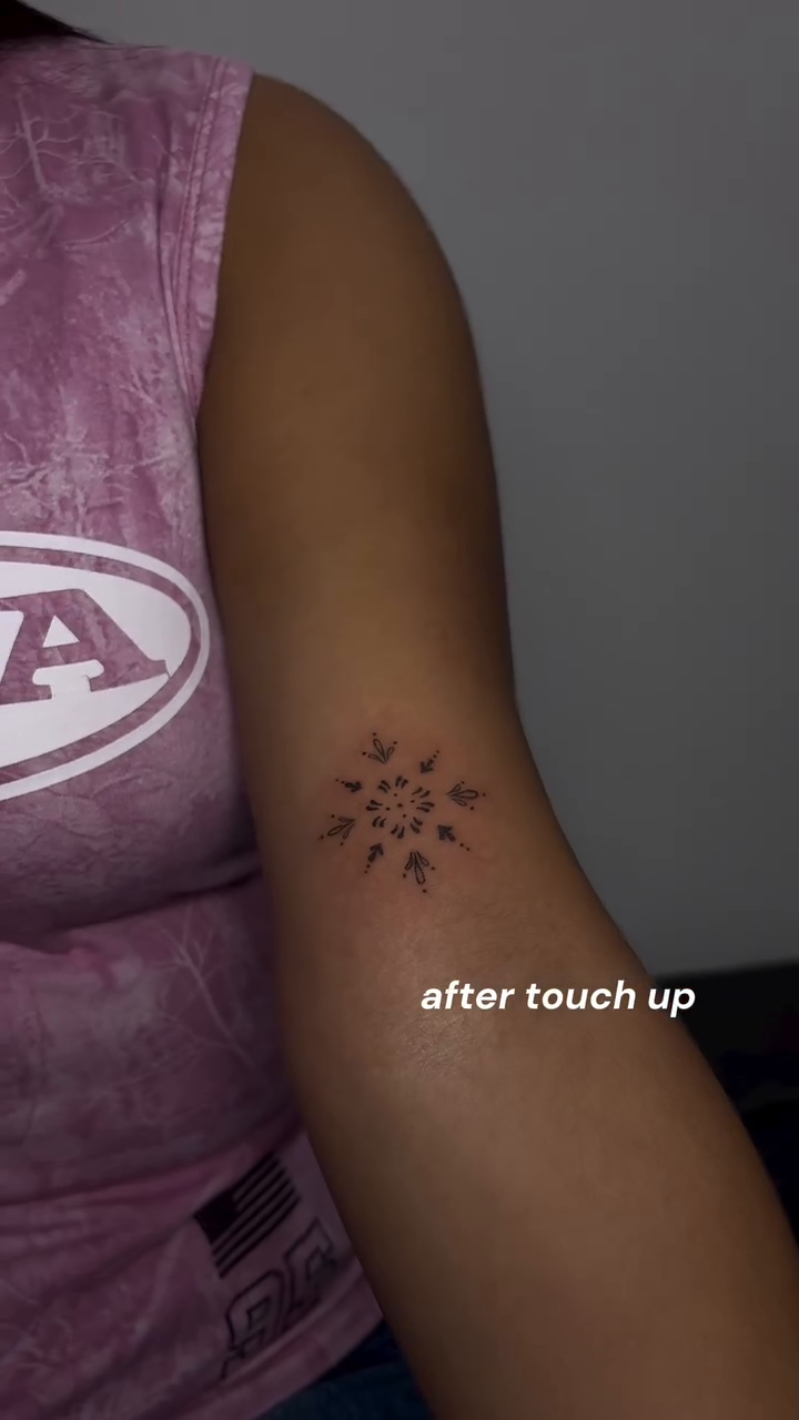 Sunburst tattoo on arm ornamental tattoo on the upper arm by Valentina