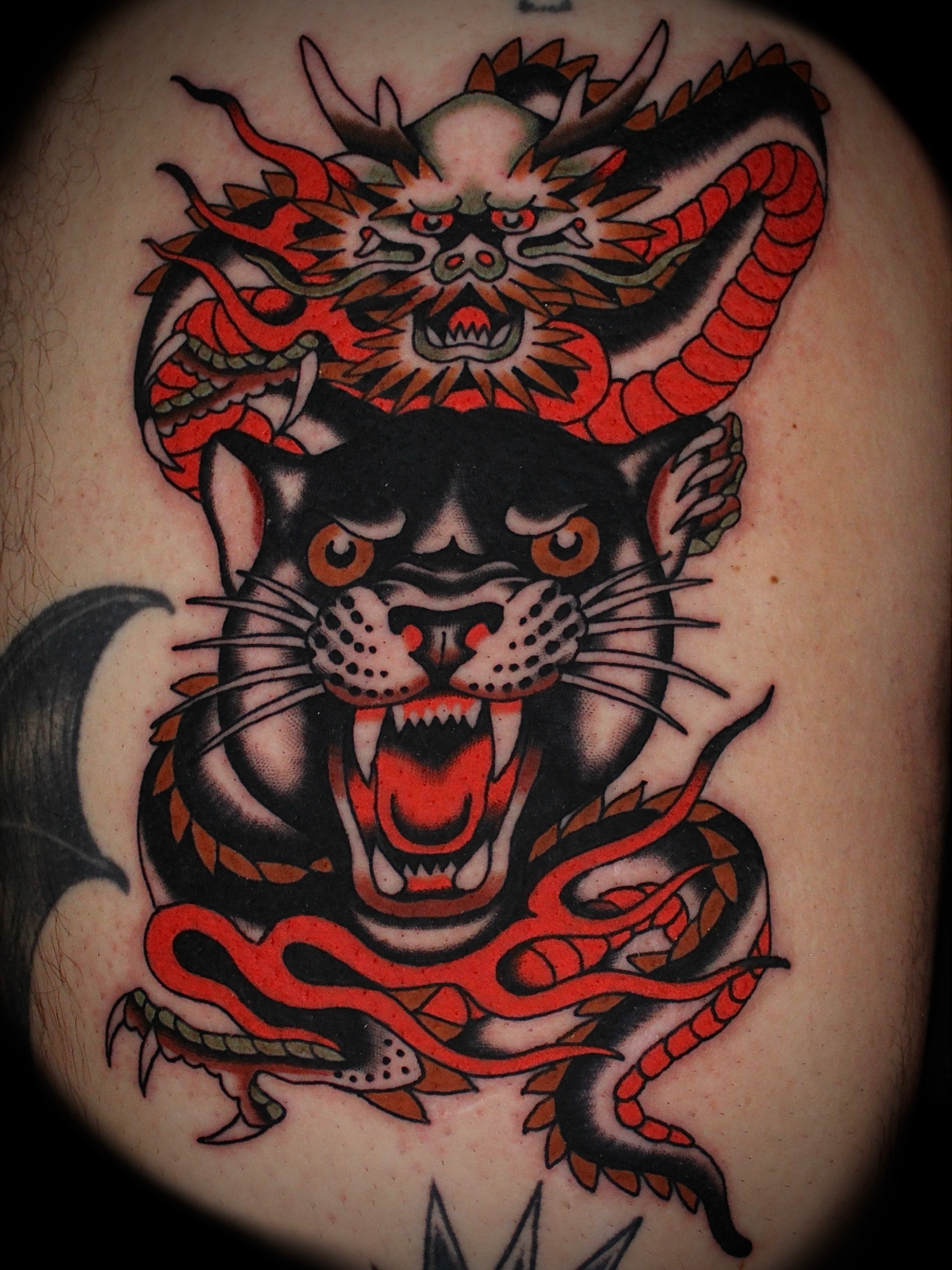 Panther and dragon American traditional tattoo on the shoulder by Dustin Stemen, Charlotte, North Carolina