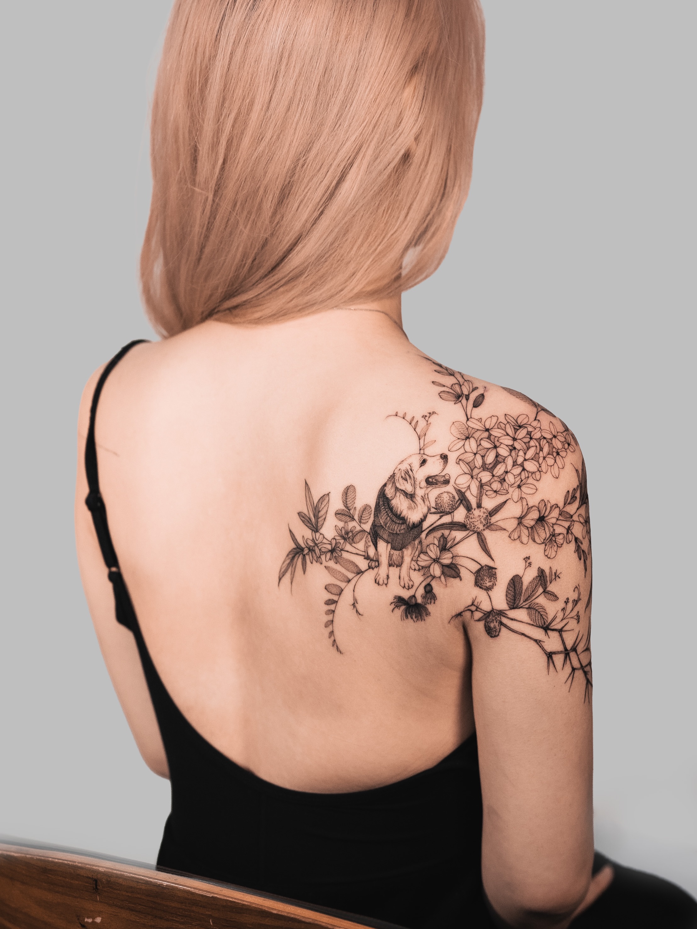 Cherry blossoms and squirrel black and grey tattoo on the shoulder by Yuliia Babych tattoo AUSTIN