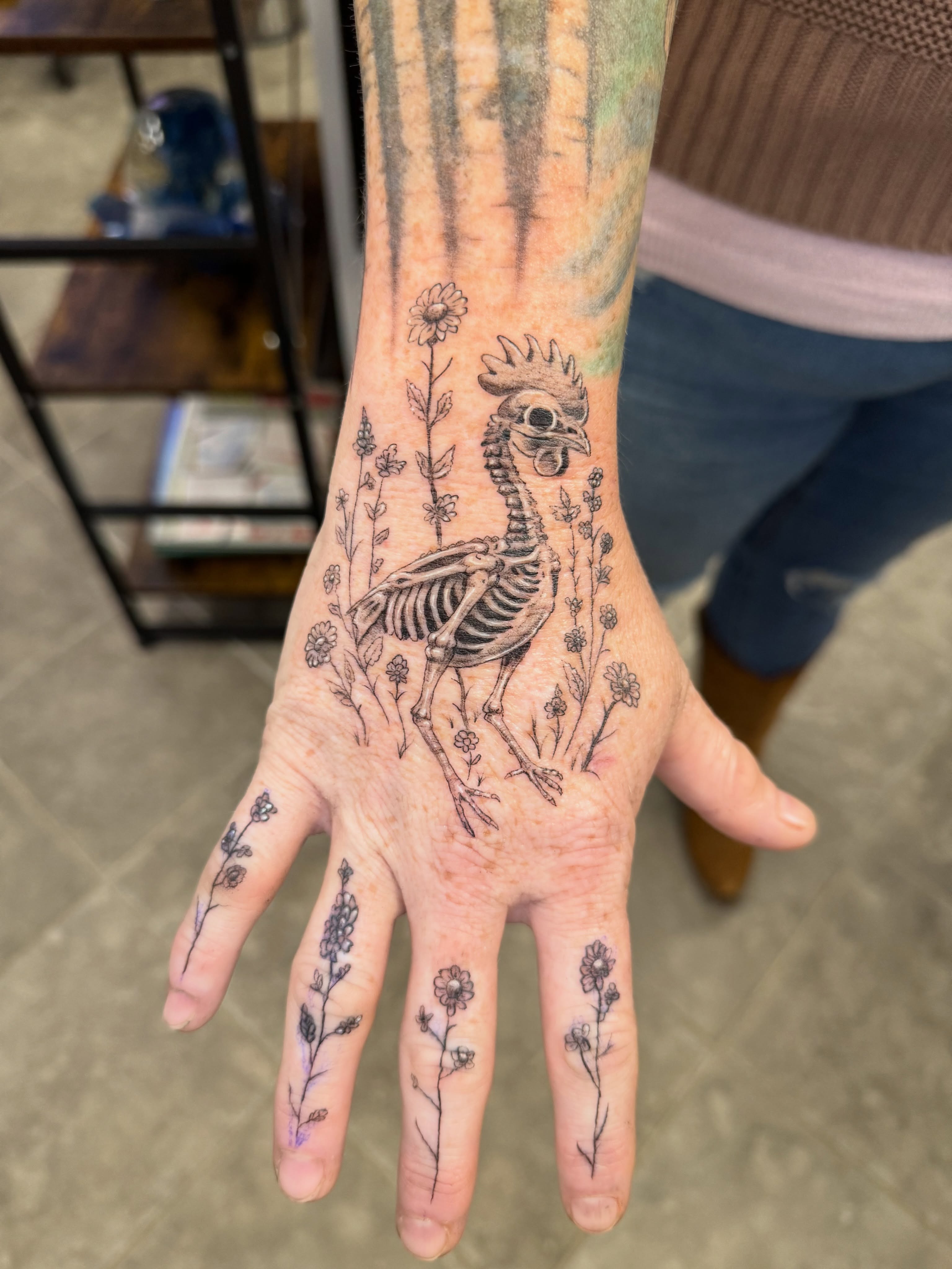 Skeleton bird black and grey tattoo on the hand by Juan Guzman
