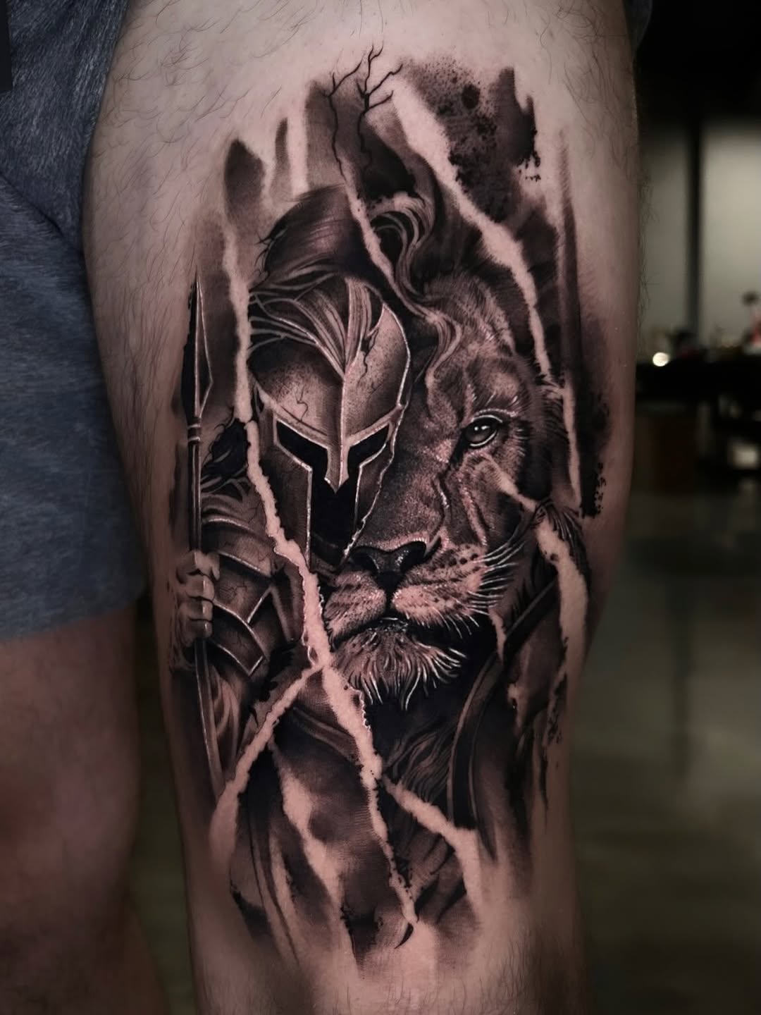 Lion and spartan warrior realism tattoo on the thigh by Dallas Corsmeier
