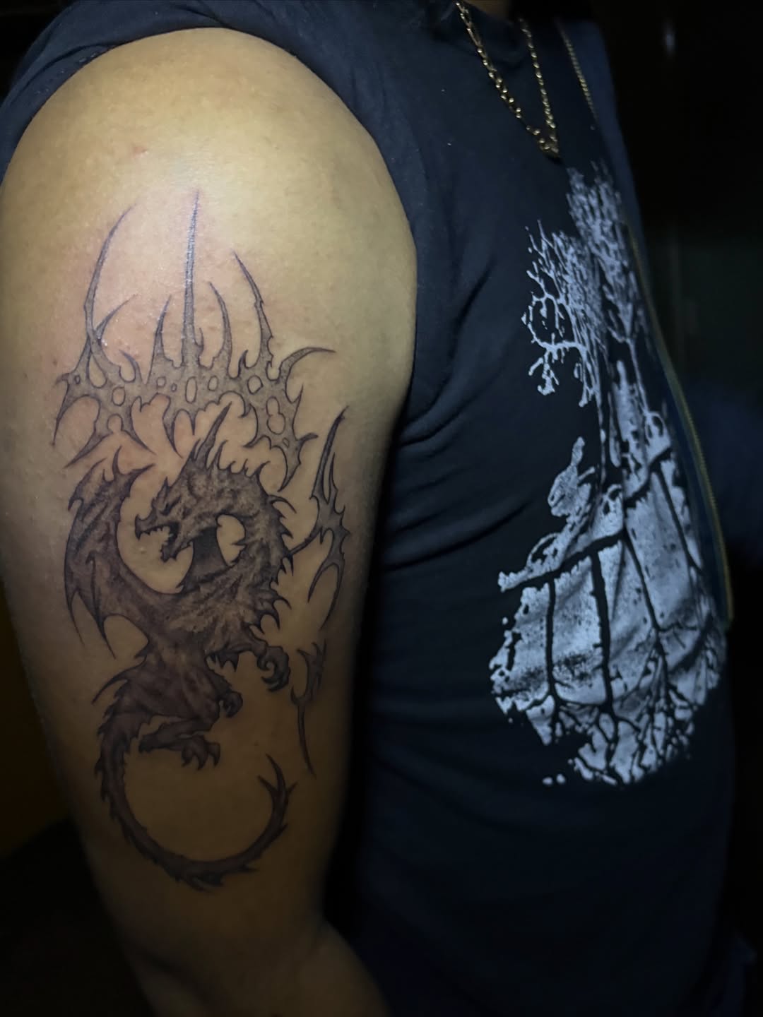 Dragon with tribal crown blackwork tattoo on the shoulder by winrytattoome