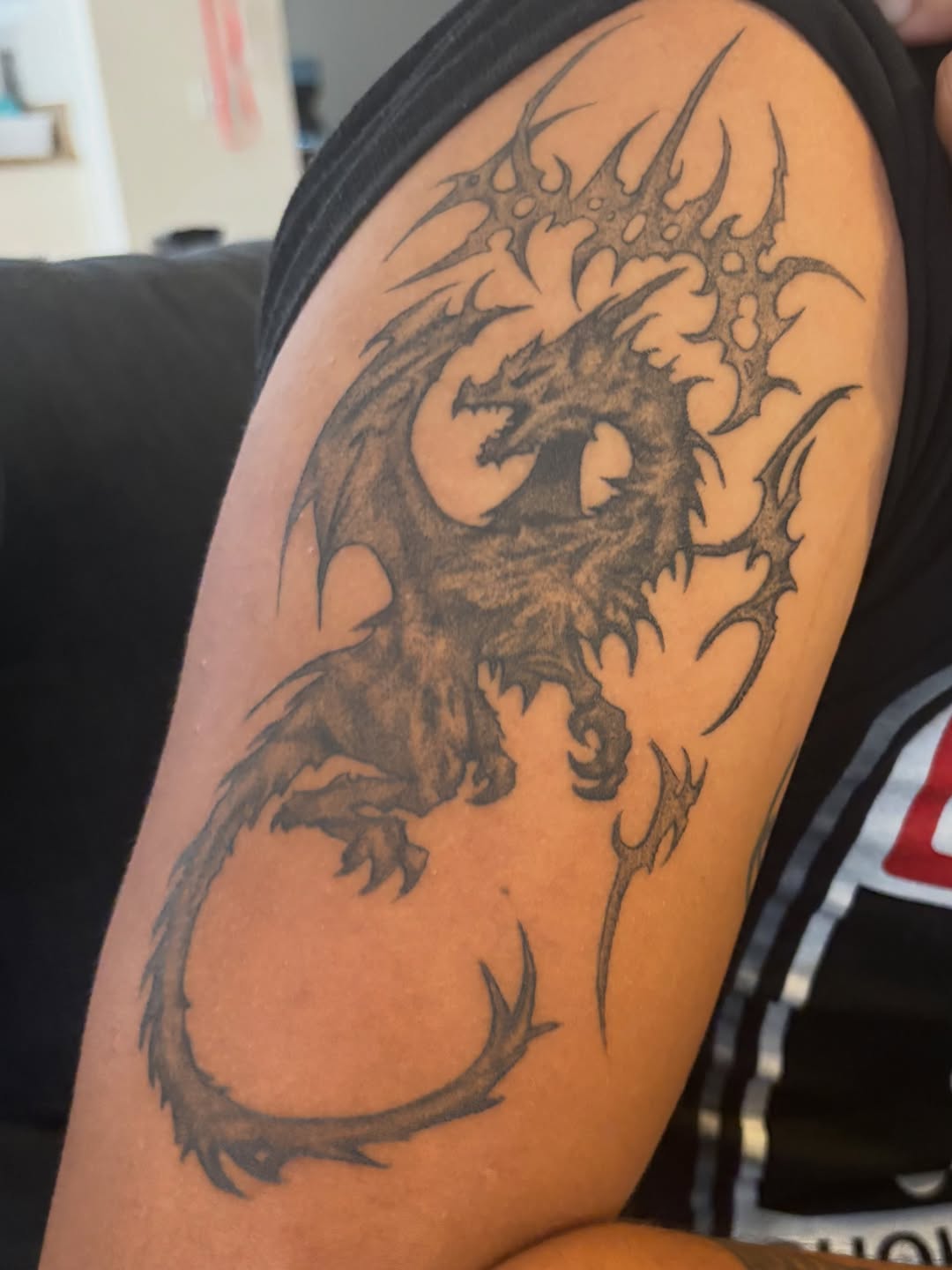 Dragon blackwork tattoo on the shoulder by winrytattoome