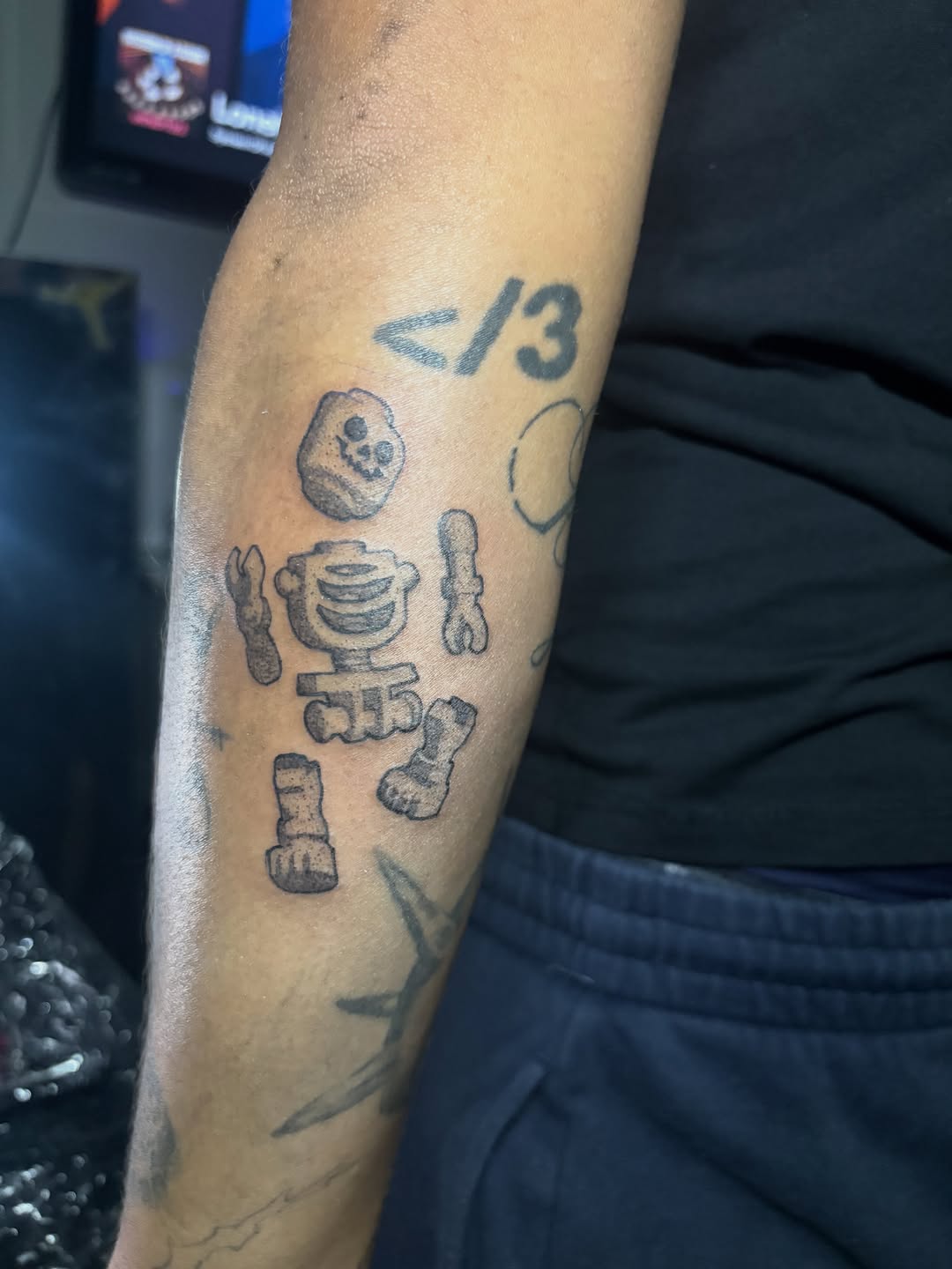 Lego skeleton tattoo on the forearm by winrytattoome