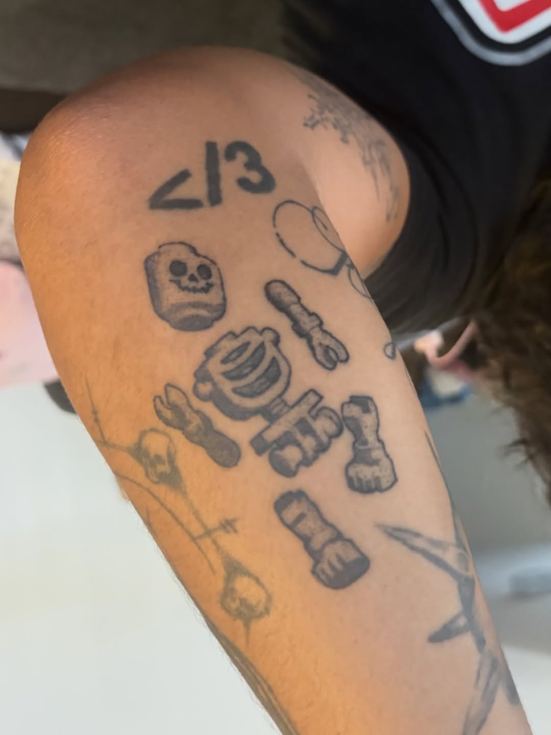 Lego skeleton ignorant tattoo on the forearm by winrytattoome