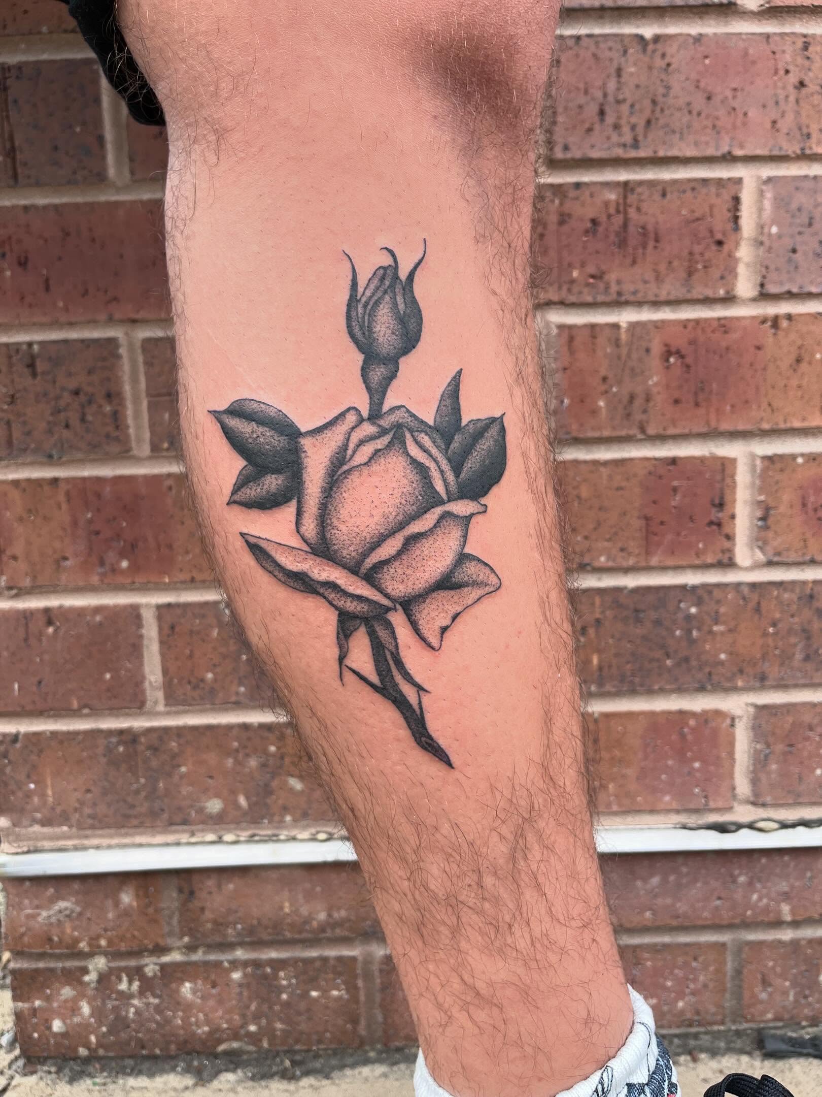 Rose black and grey tattoo on the thigh by Jackson Kirchhoff