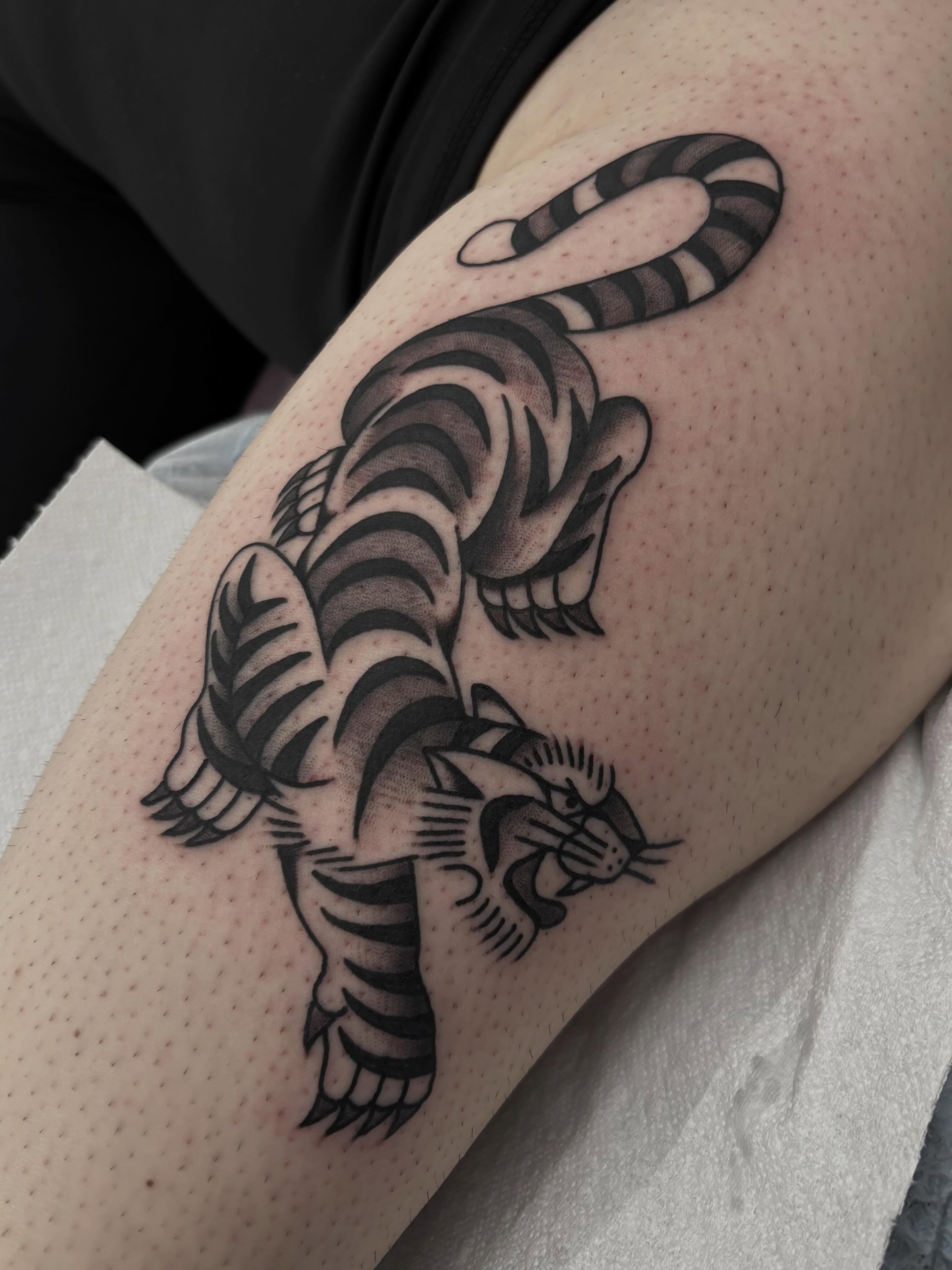 Tiger American traditional tattoo on the forearm by Claire Anderson