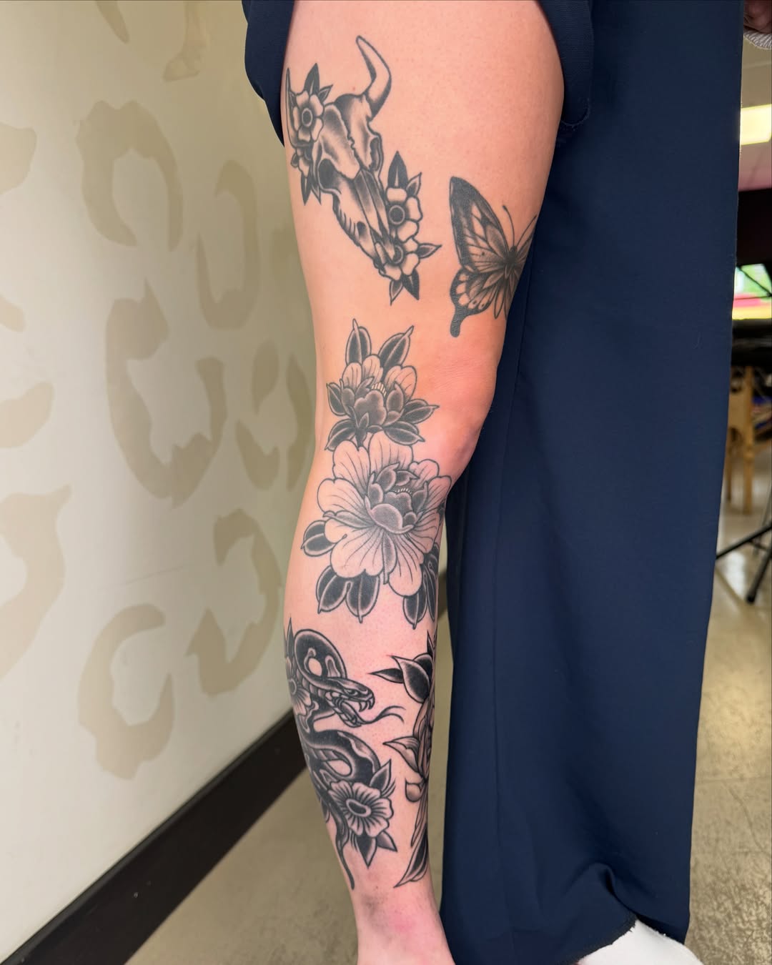Floral and insect motifs black and grey tattoo on the forearm by Bre Grover, Vancouver, British Columbia