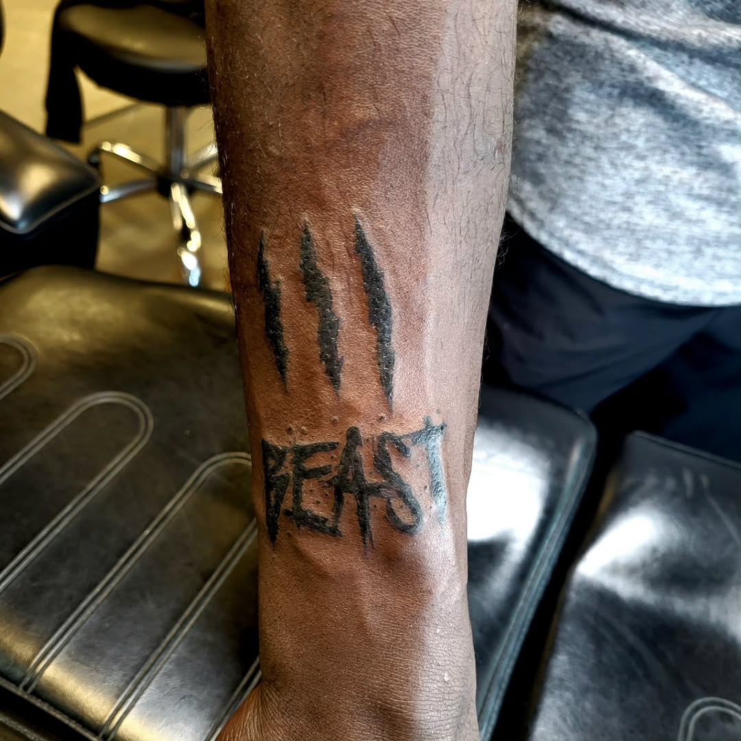 Tattoo by @cryingwoof — lettering_script, blackwork