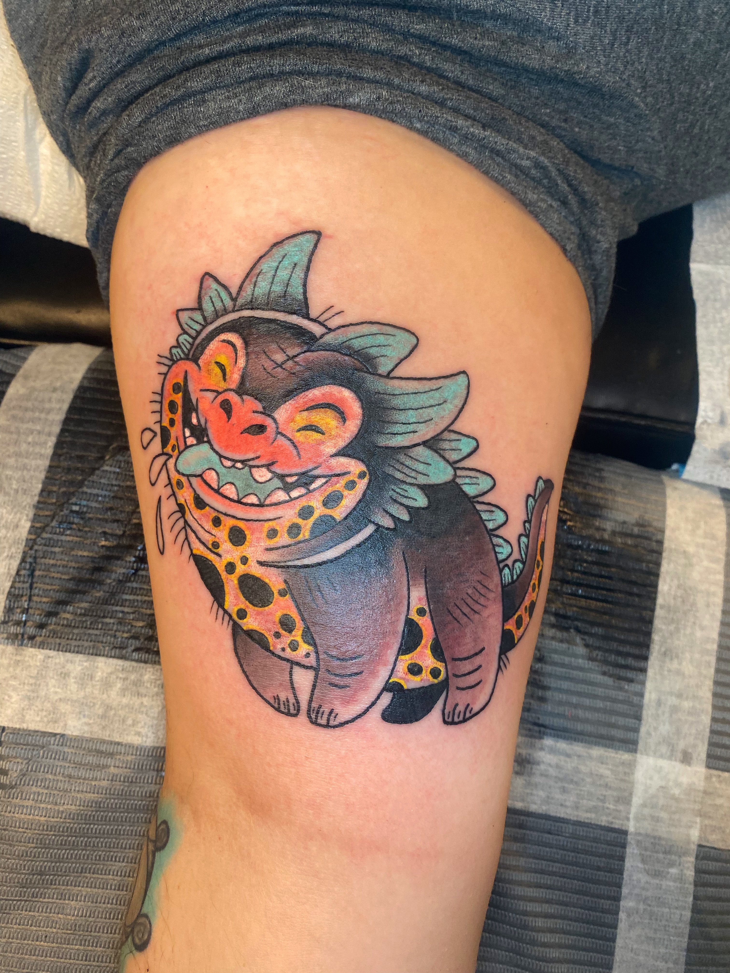 Lion American traditional tattoo on the thigh by Aidan Monahan Tattoo
