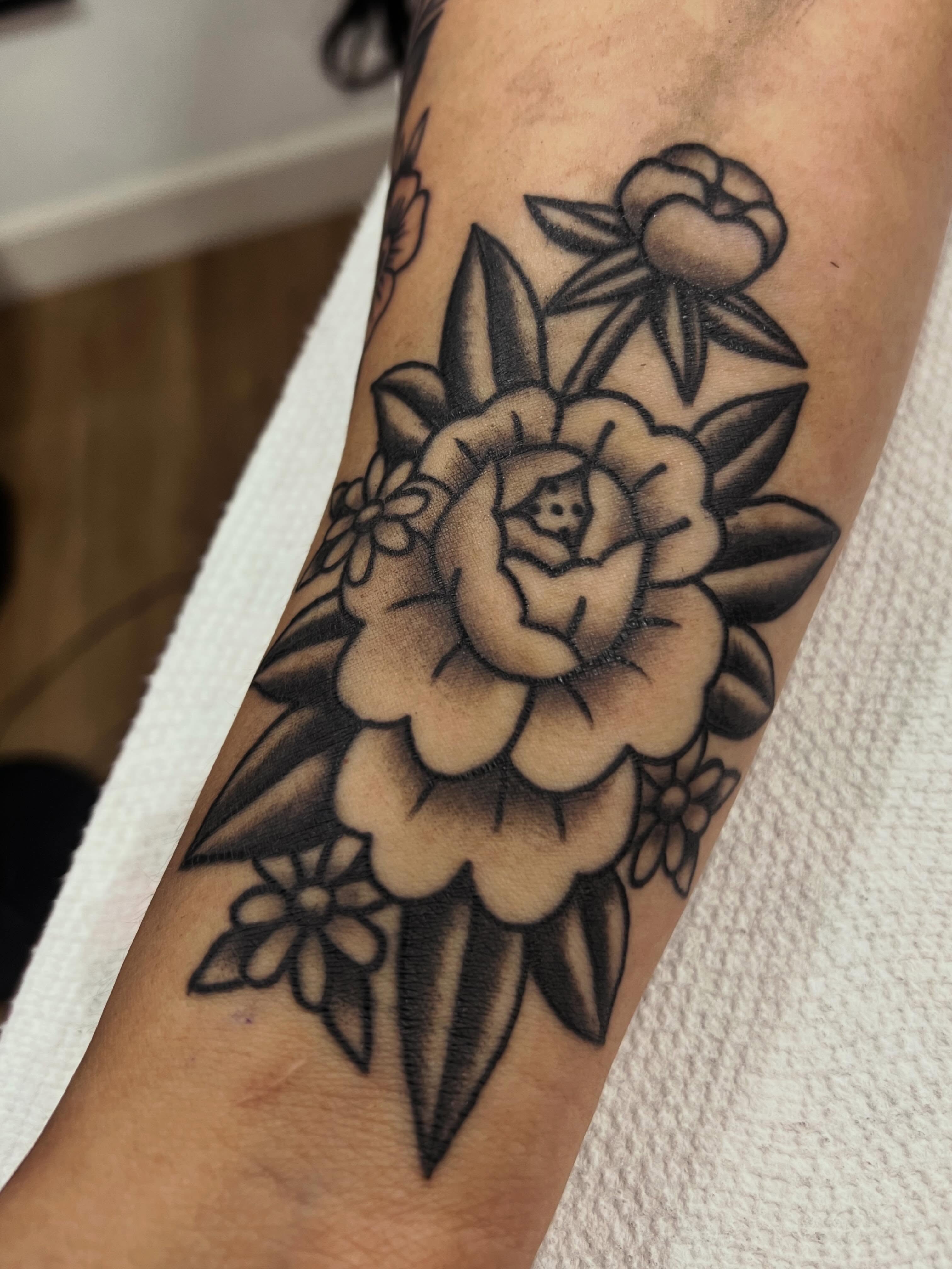 Peony black and grey tattoo on the forearm by Samantha Citer