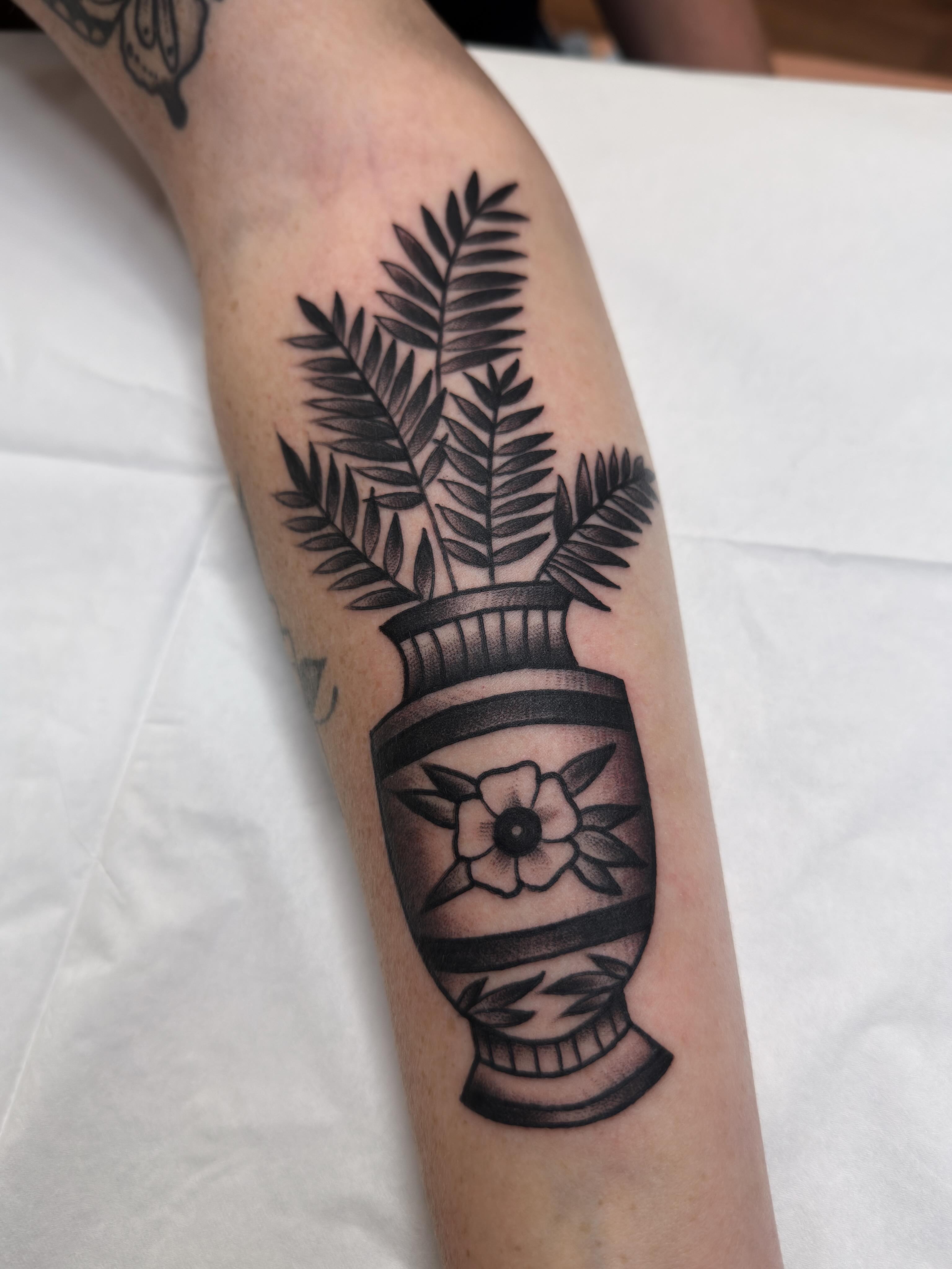 Urn with flowers black and grey tattoo on the forearm by Trav, Bayville, New Jersey