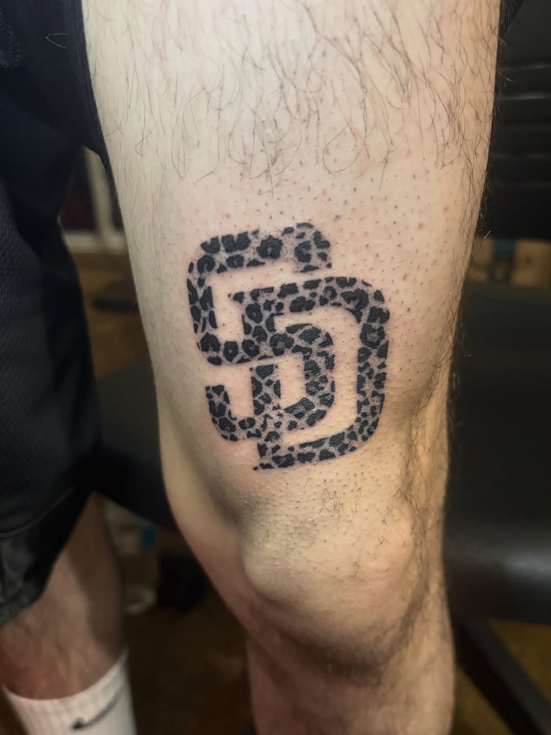 SD logo with leopard print fill realism tattoo on the forearm by winrytattoome