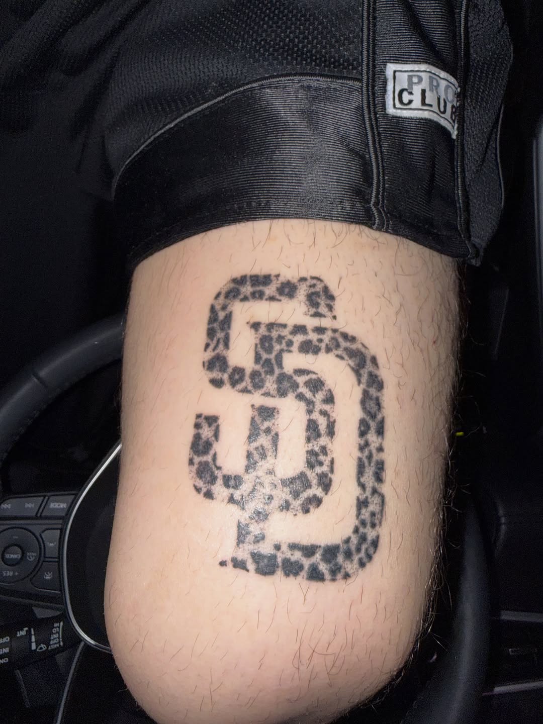 SD logo with leopard print fill tattoo on the thigh by winrytattoome