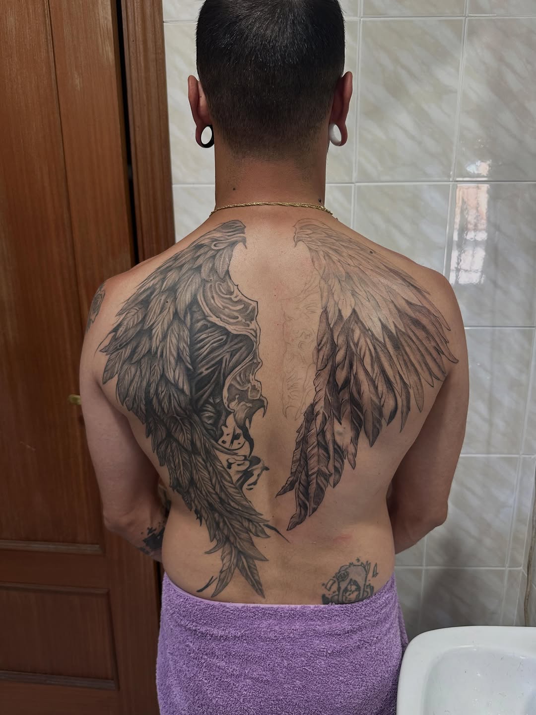 Angel wings realism tattoo on the back by Kunaytattoo