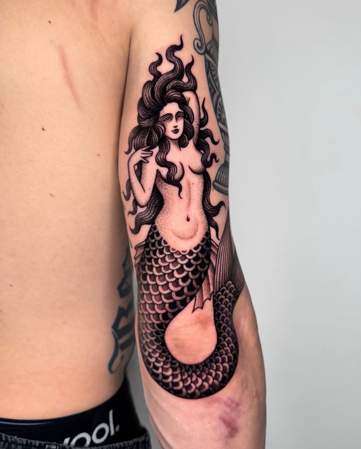 Mermaid American traditional tattoo on the thigh by Jae Traditional Tattoo