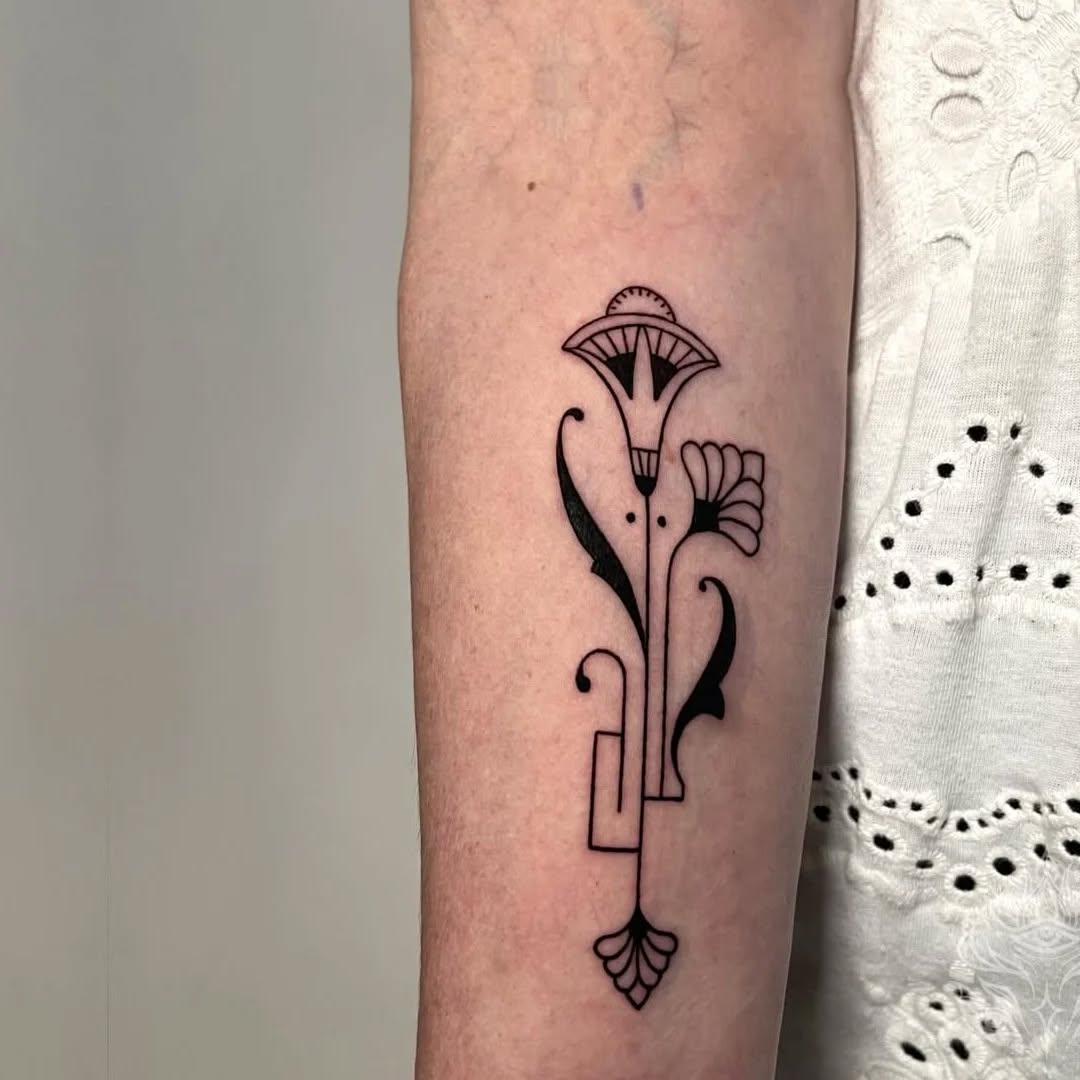 Egyptian lotus flower and geometric elements ornamental tattoo on the forearm by Donavon Batz
