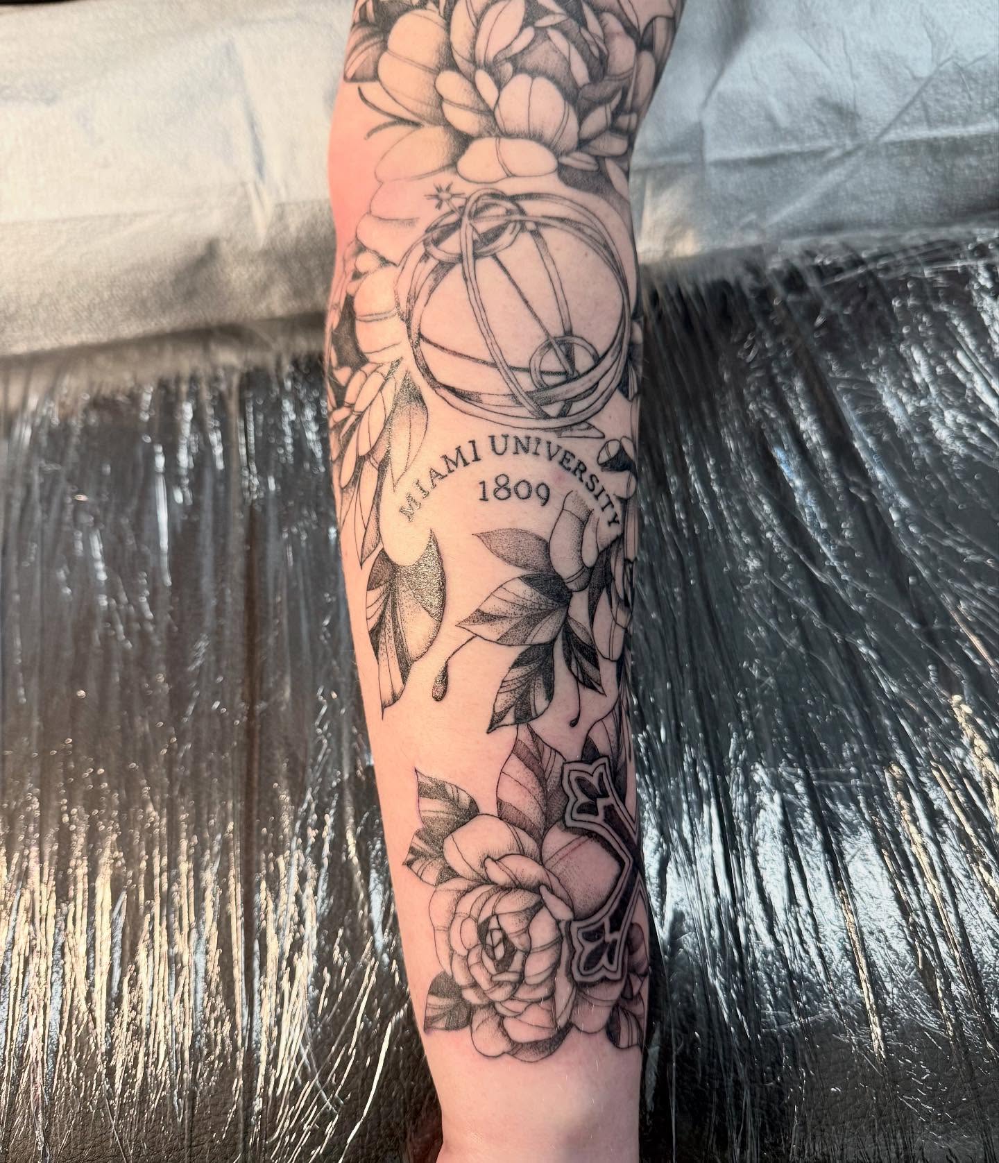Miami university black and grey tattoo on the forearm by C.J. Pennington