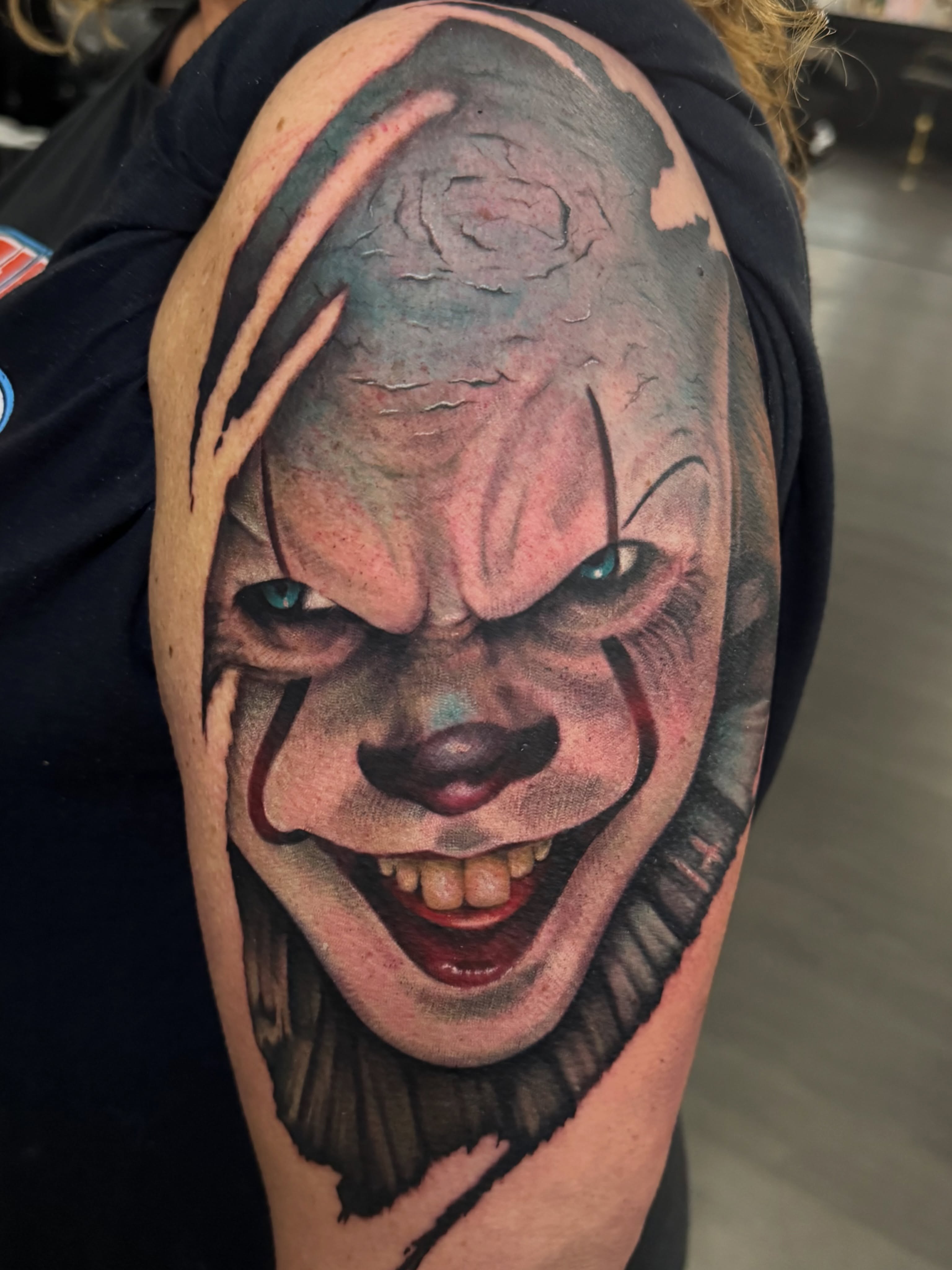 Clown face realism tattoo on the shoulder by Dustin Kaiser, Mentor, Ohio