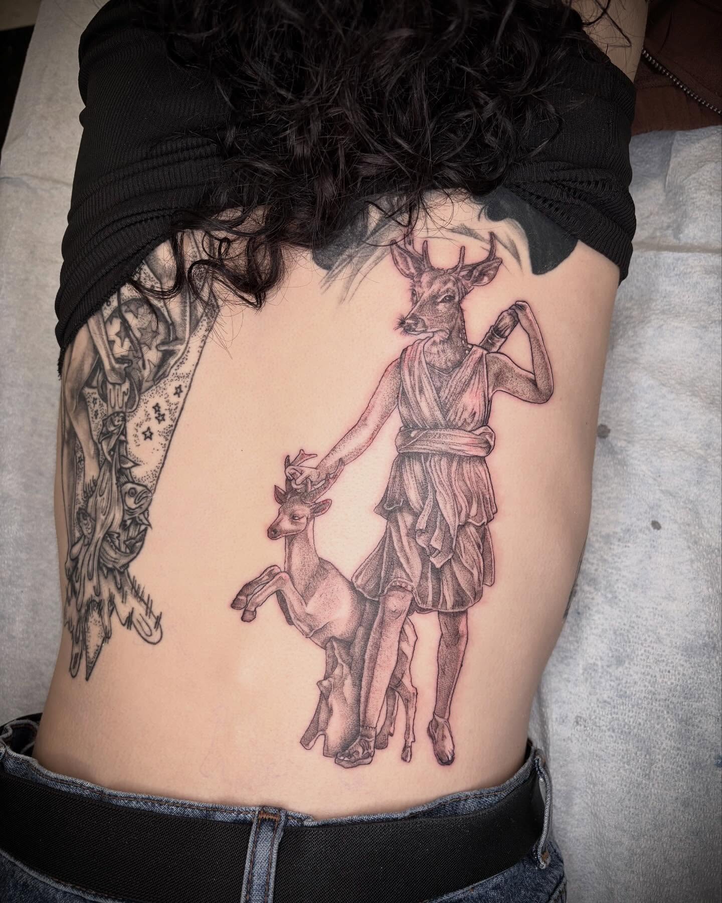 Deer and man realism tattoo on the ribs by Emily Falkowski