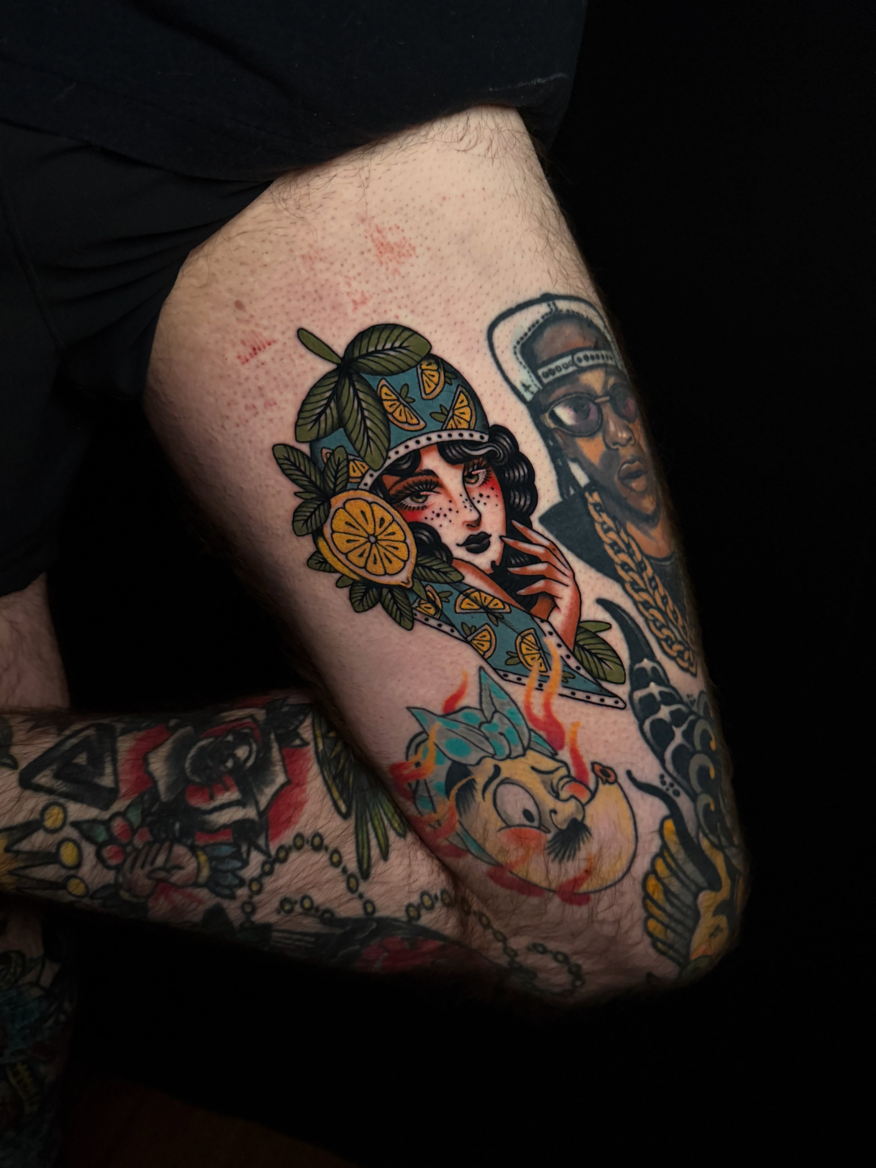 Flapper girl with lemon American traditional tattoo on the thigh by Brad Snow