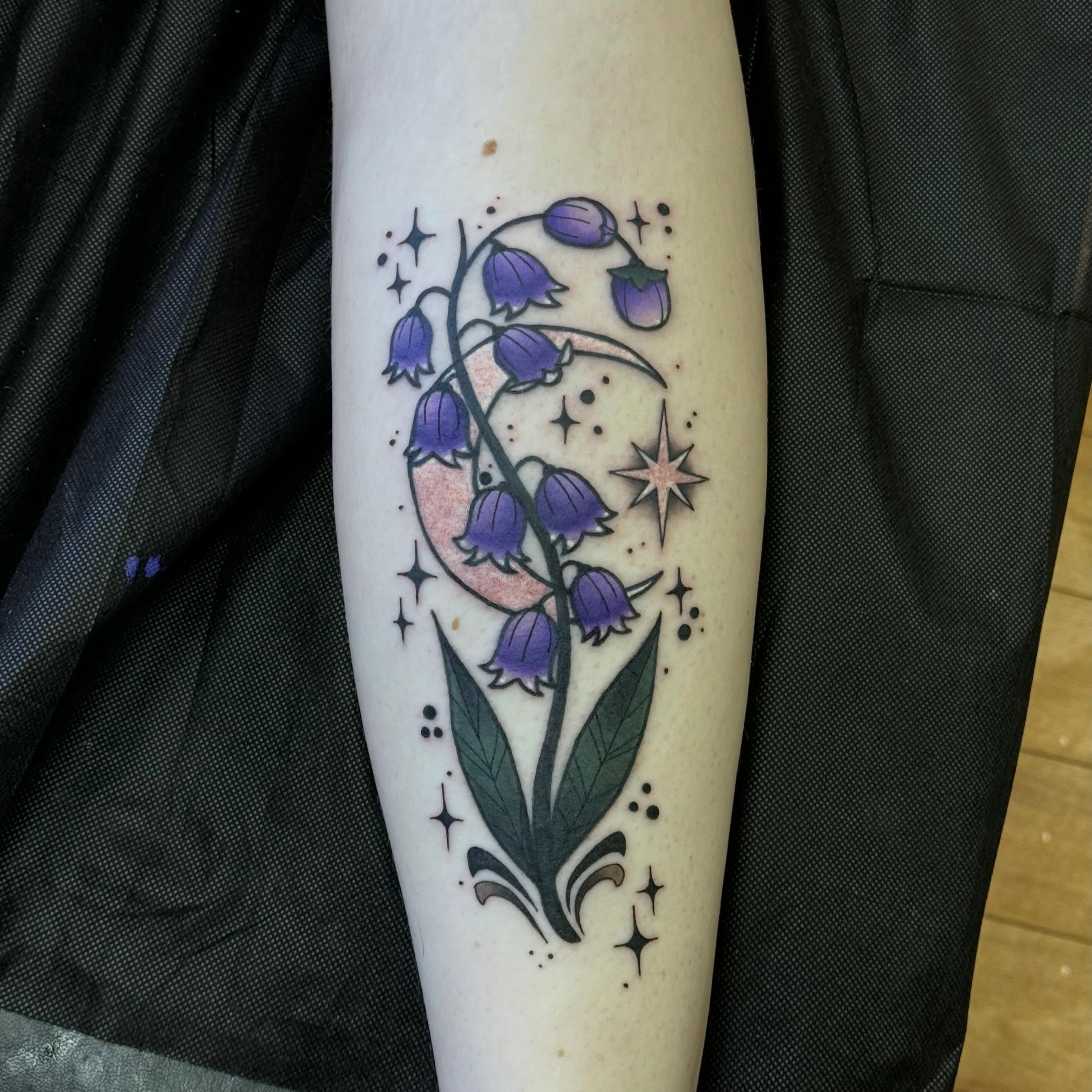 Bluebell flowers and crescent moon dotwork tattoo on the forearm by Nic