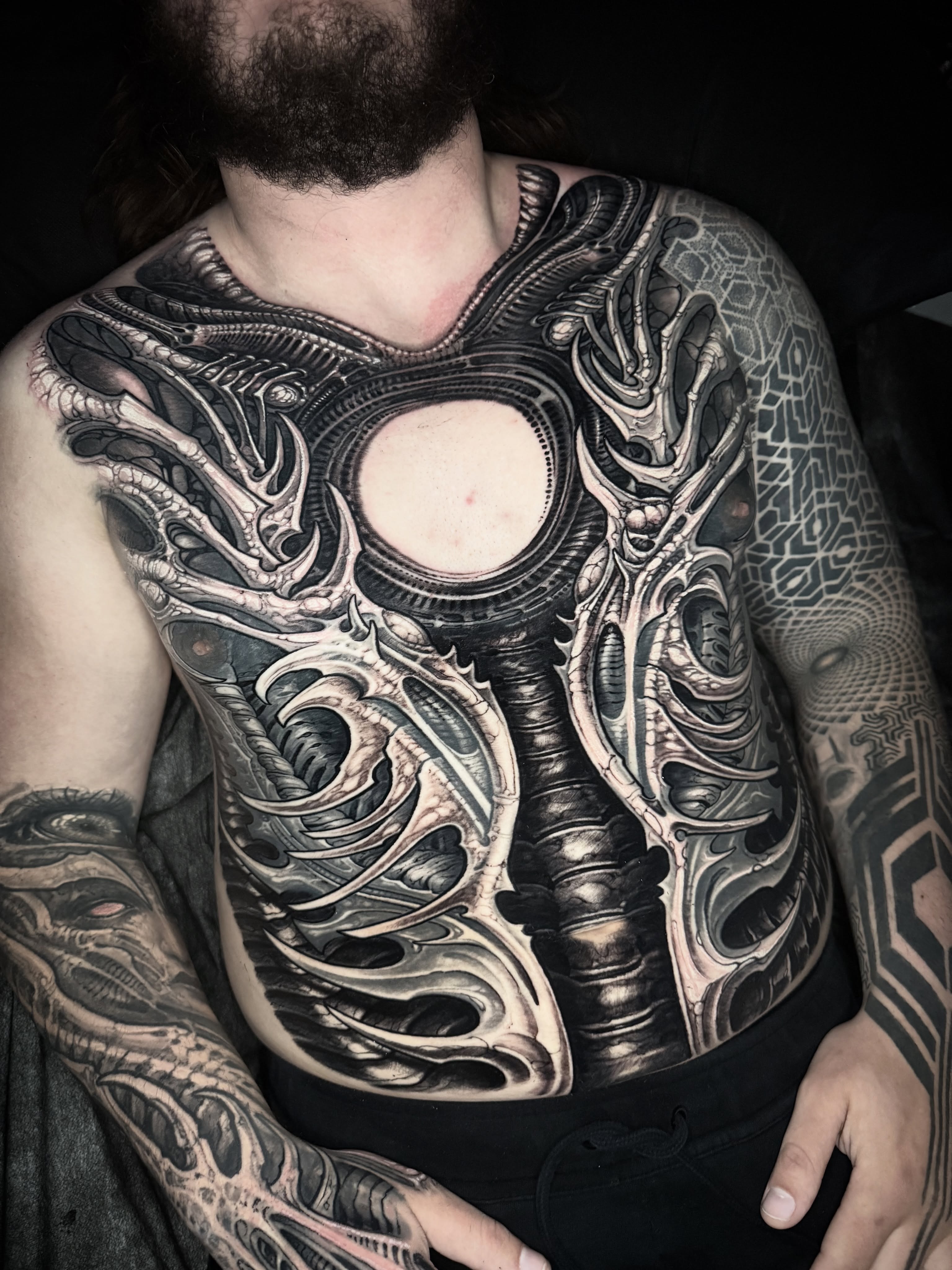 Biomechanical armor geometric tattoo on the chest by Jeremiah Barba