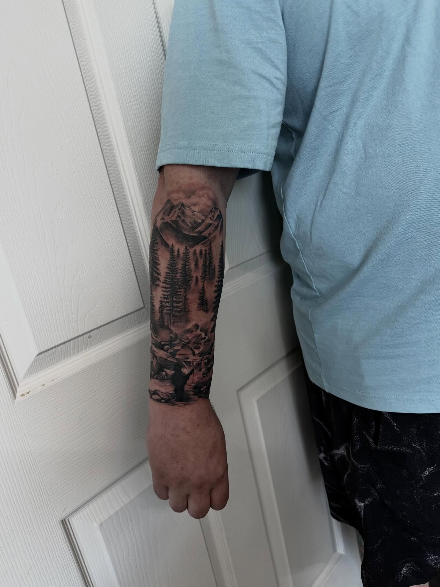 Mountain landscape realism tattoo on the forearm by Emma Mathis, Springfield, Oregon
