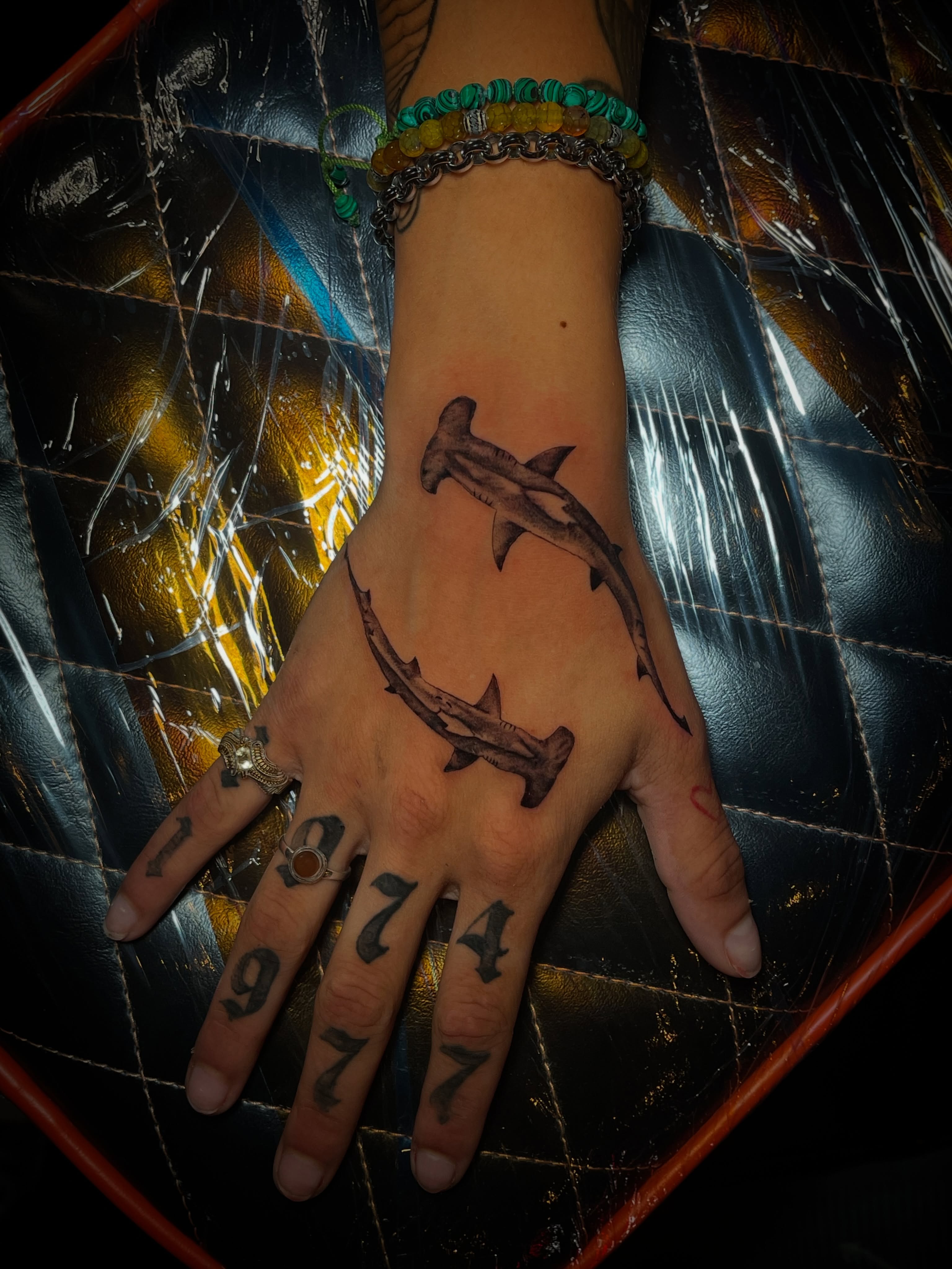 Hammerhead sharks black and grey tattoo on the hand by MoogieTats