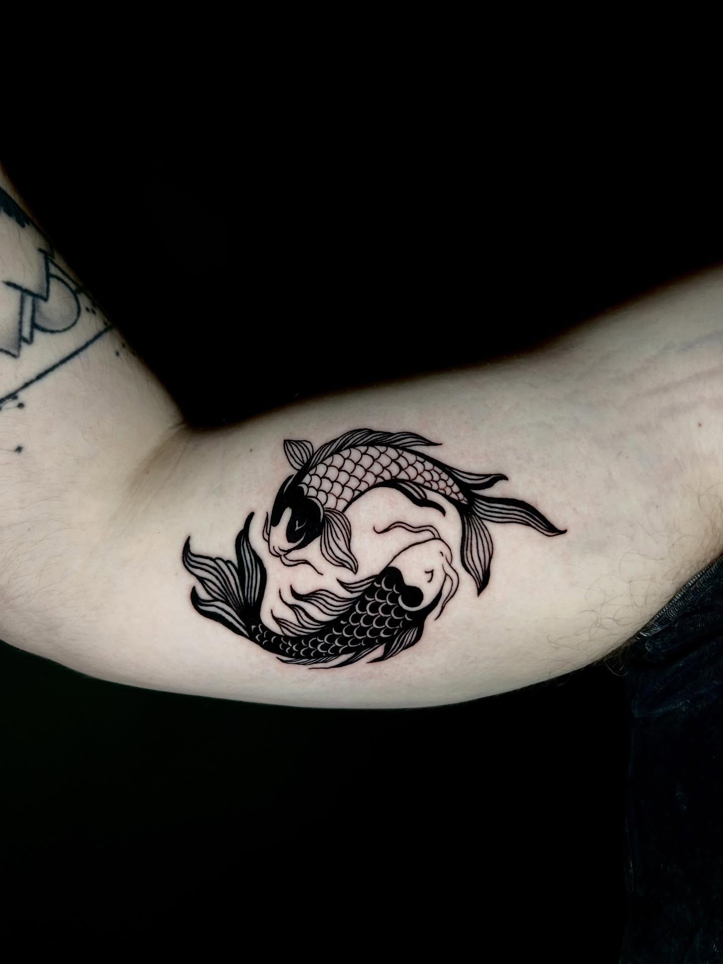Yin yang fish black and grey tattoo on the forearm by KB