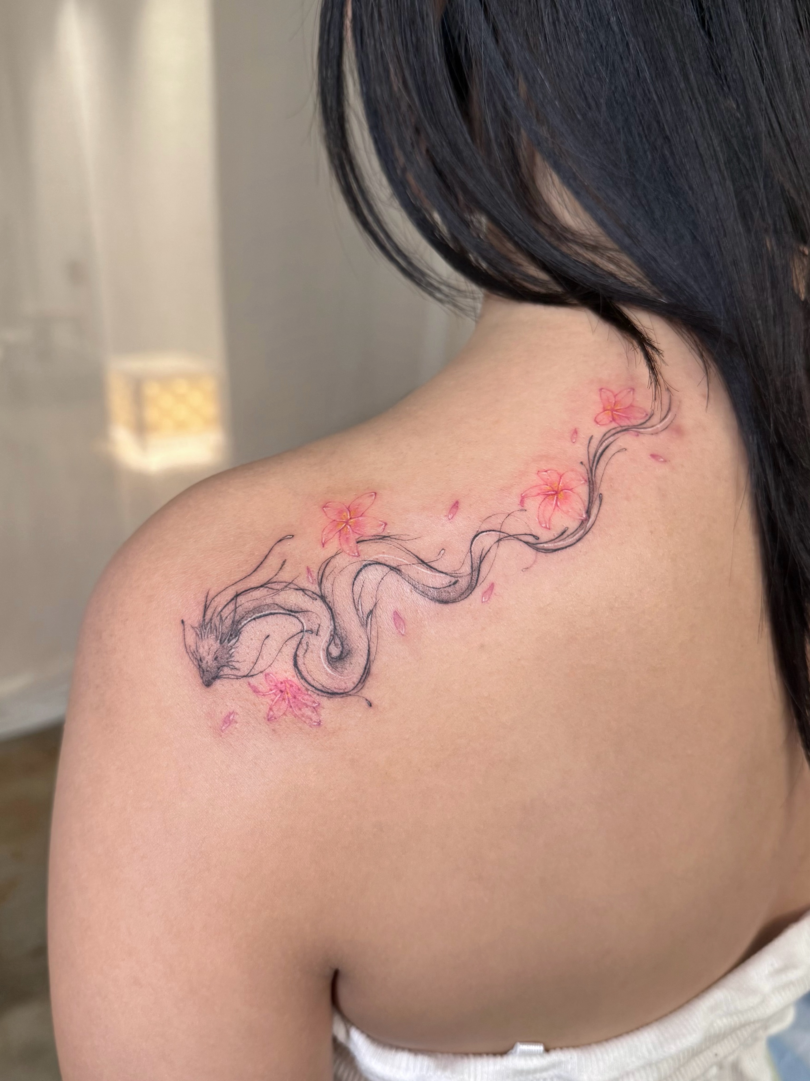 Cherry blossom dragon dotwork tattoo on the shoulder by ๐๐๐๐๐๐