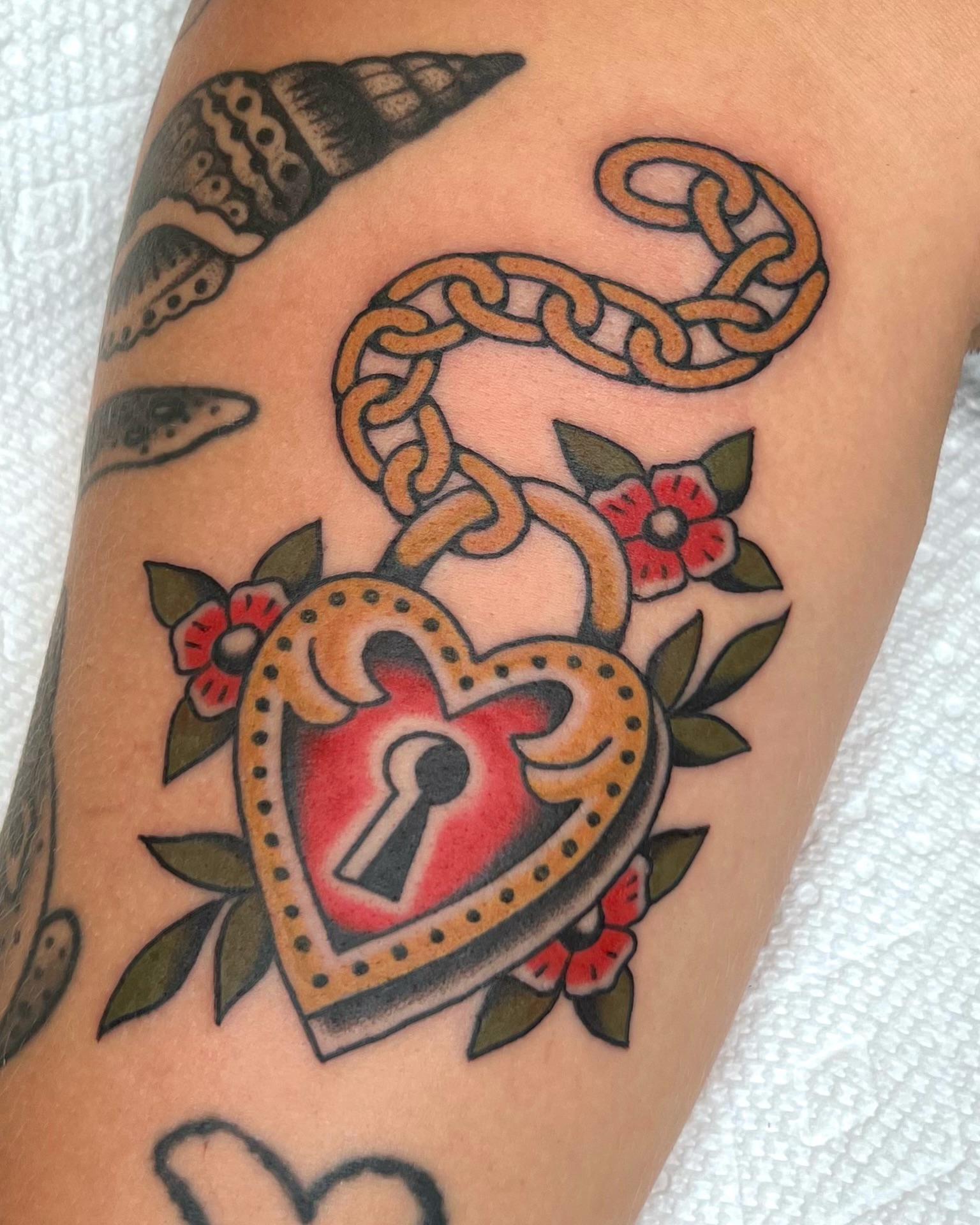Heart lock American traditional tattoo on the forearm by Brian Visser