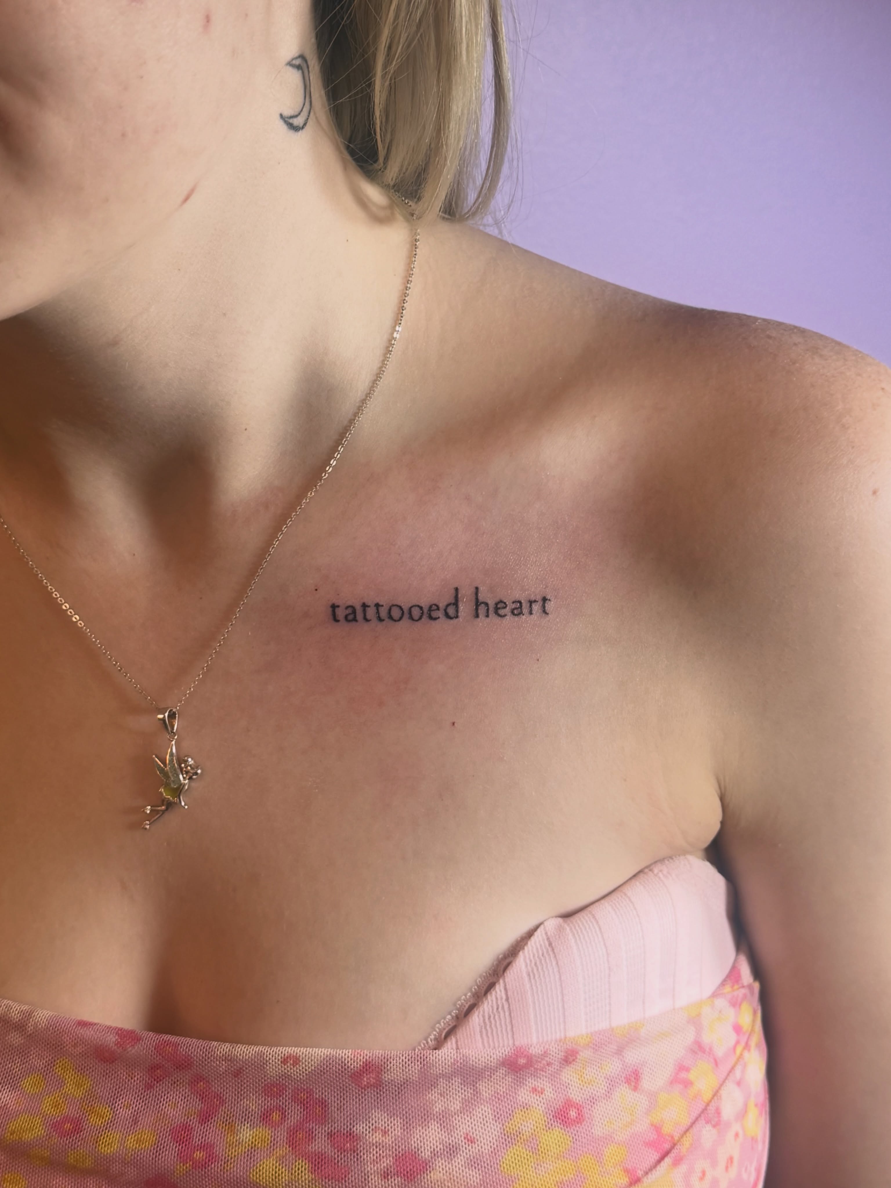 Tattooed heart lettering script tattoo on the chest by Jay