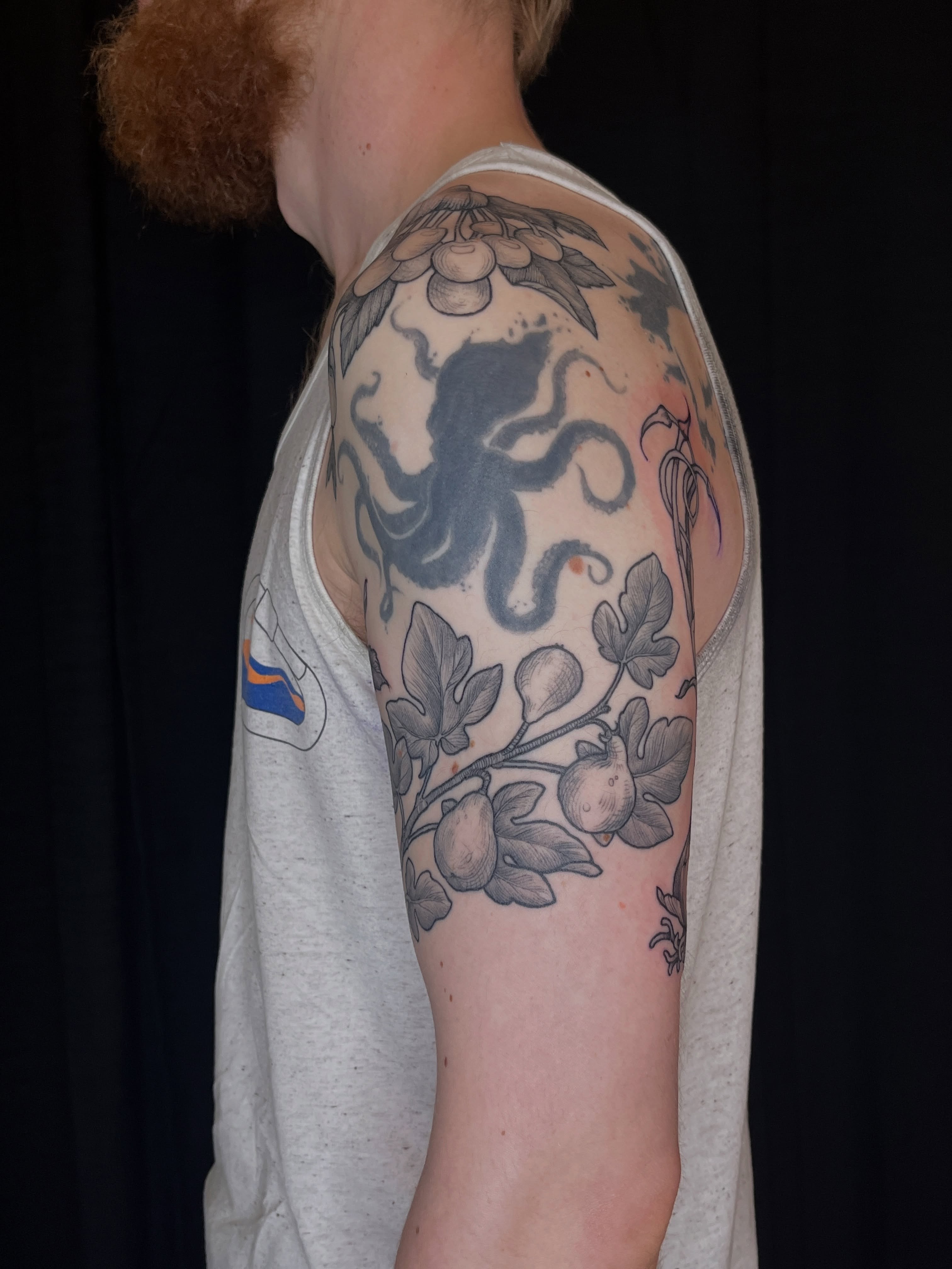 Octopus and figs black and grey tattoo on the upper arm by BELLIE ✧ Tattoo Artist