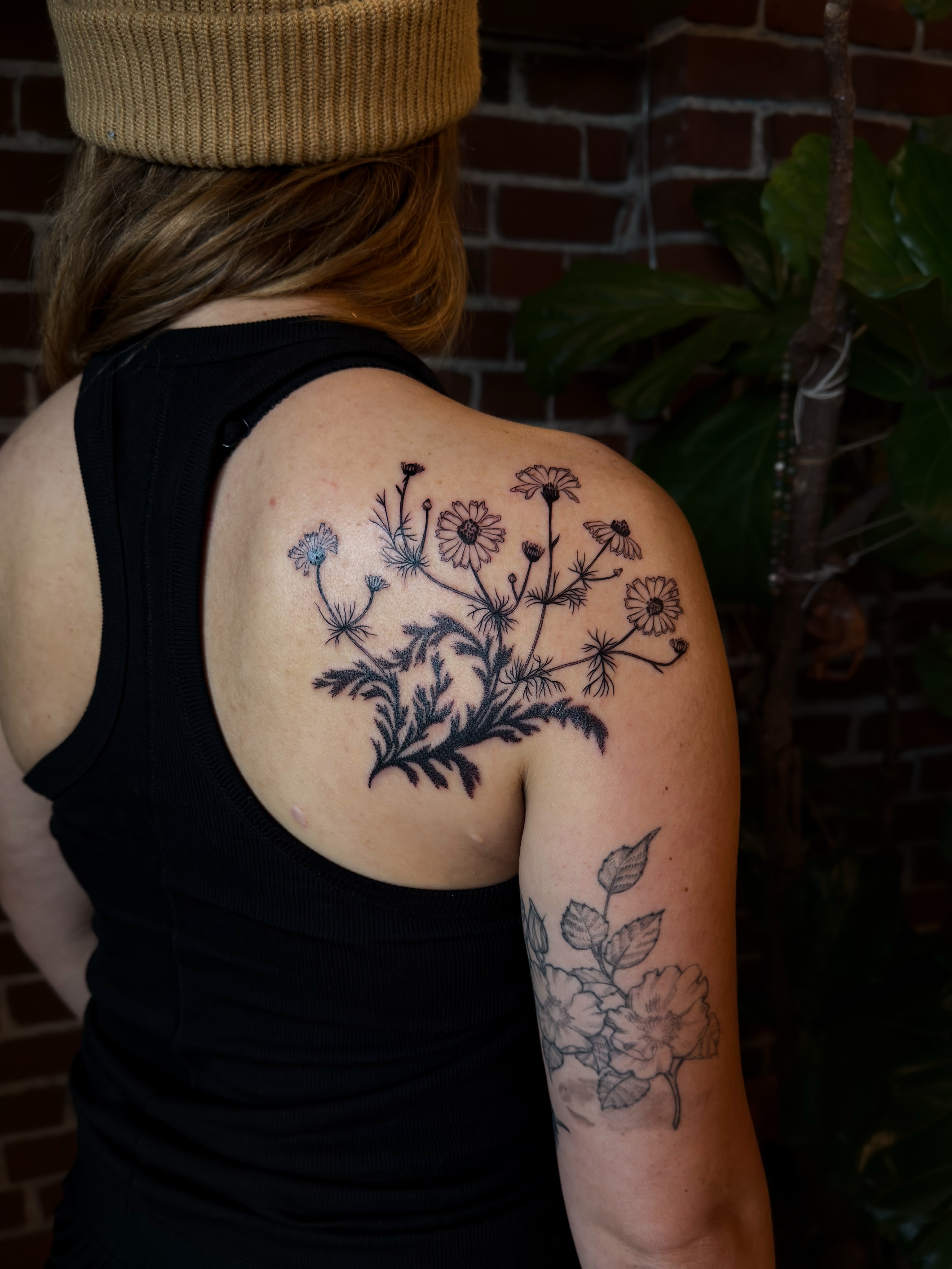 Wildflowers black and grey tattoo on the shoulder by Alexandra Gray