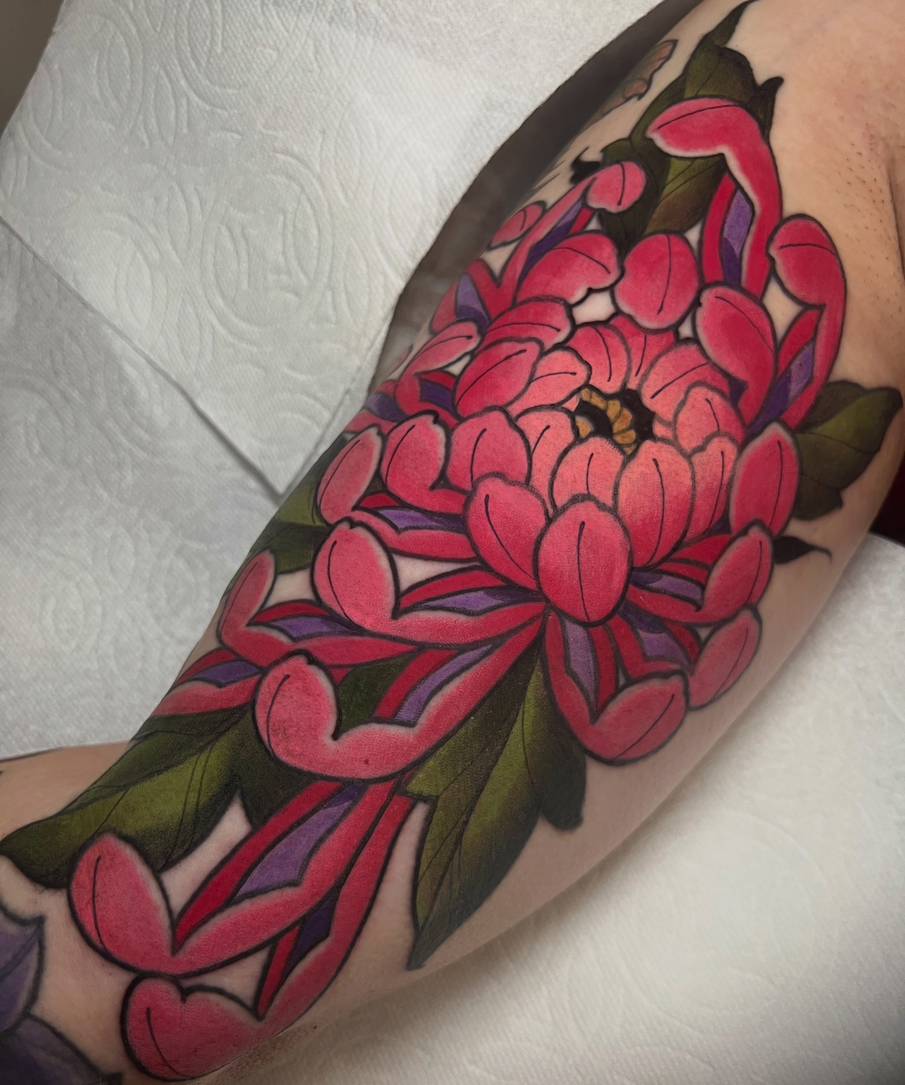 Chrysanthemum American traditional tattoo on the forearm by Rennie Tattoo
