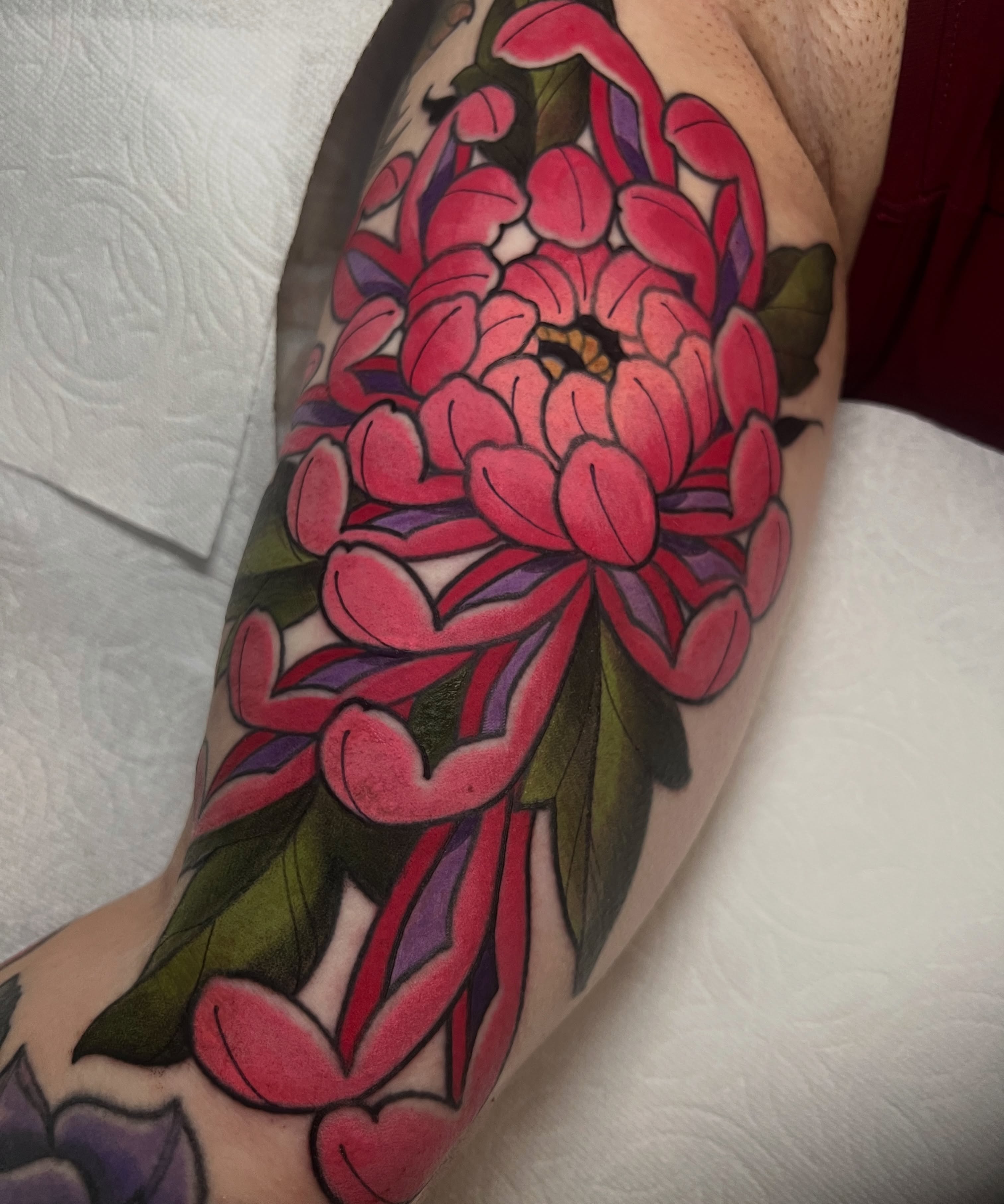 Chrysanthemum American traditional tattoo on the forearm by Rennie Tattoo