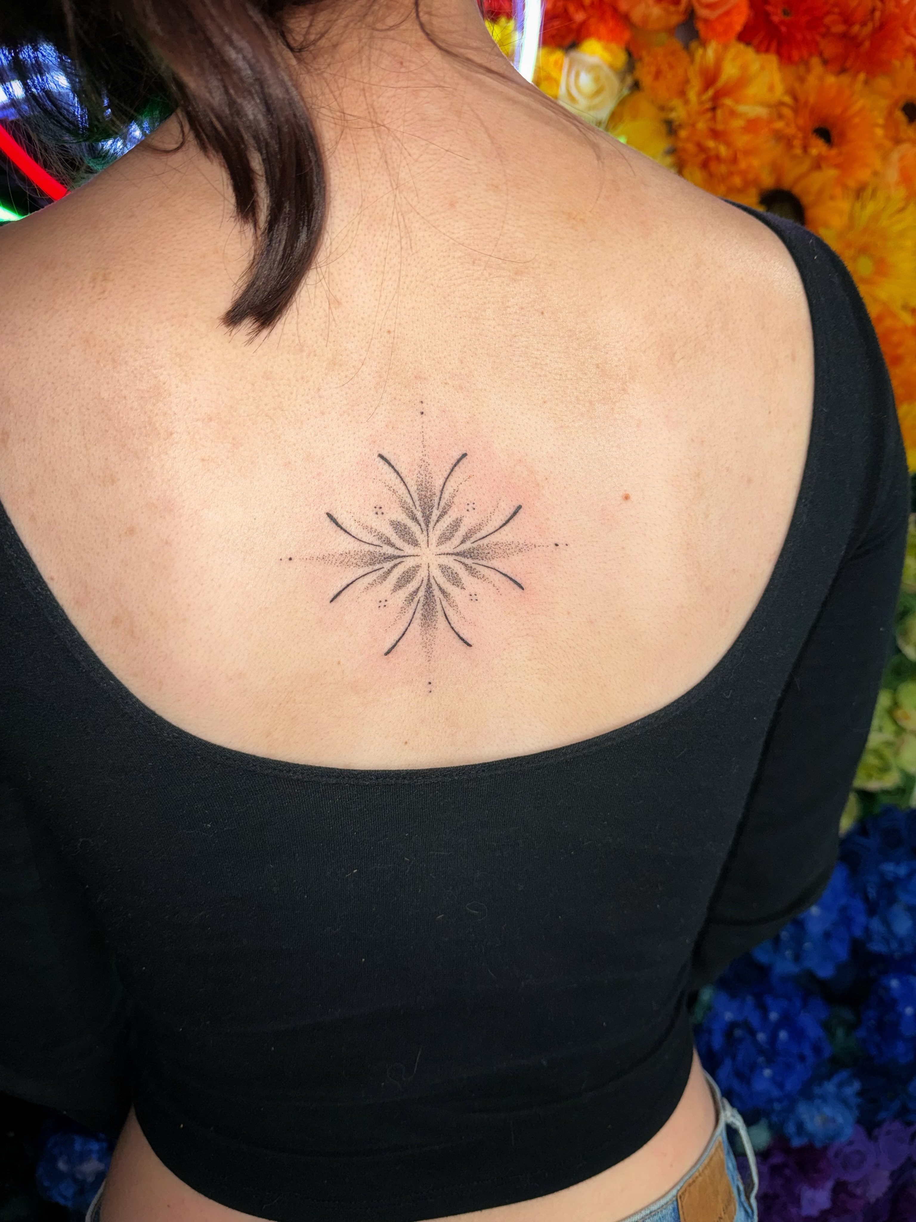 Geometric starburst dotwork tattoo on the back by Handpoke Tattoo Artist, Minneapolis, Minnesota