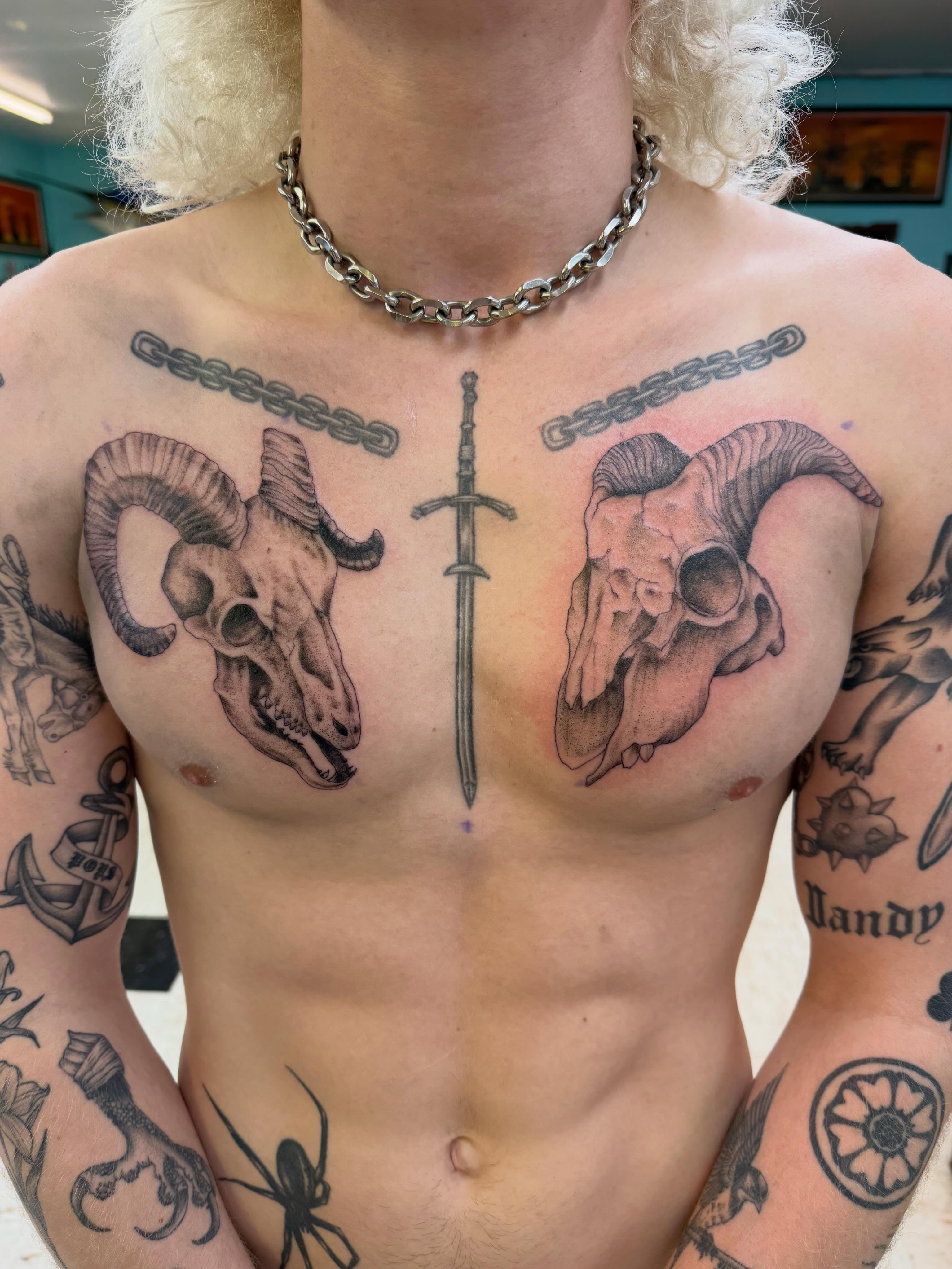 Ram skulls and sword realism tattoo on the chest by Levi Sawdon, Everett, Washington