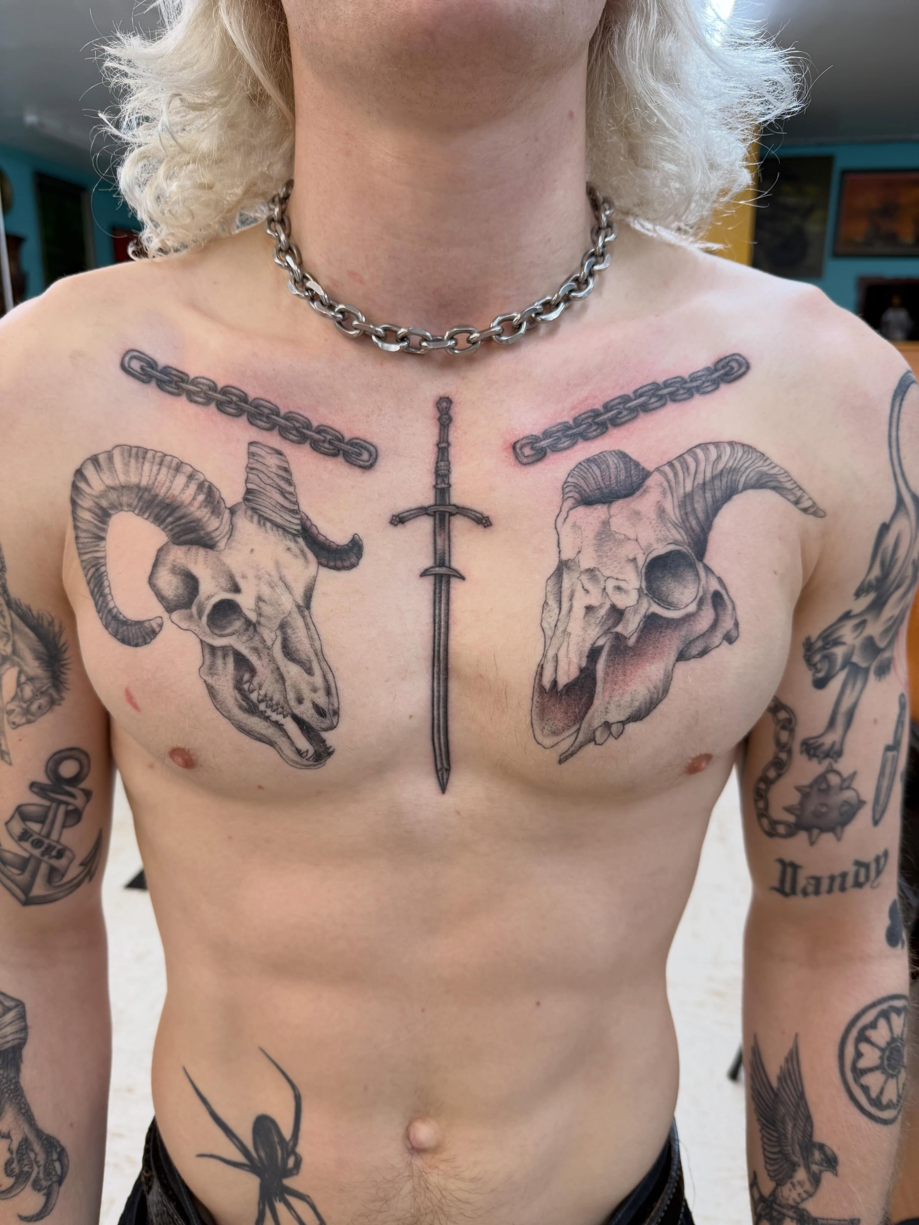 Ram skulls and sword realism tattoo on the chest by Levi Sawdon, Everett, Washington